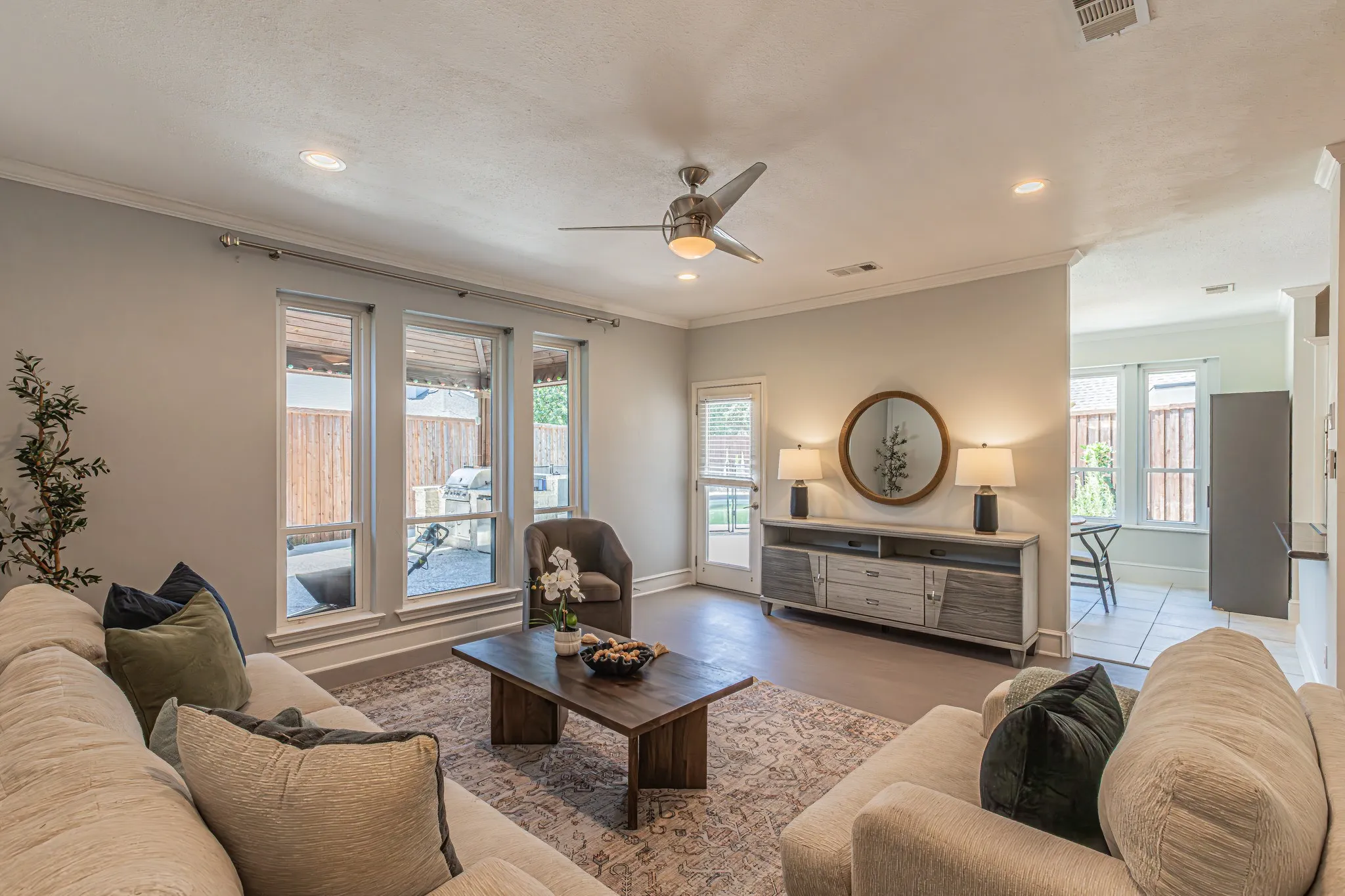 Recessed lighting, crown molding, ceiling fan, wood-finish flooring, and a glass-paneled exterior door