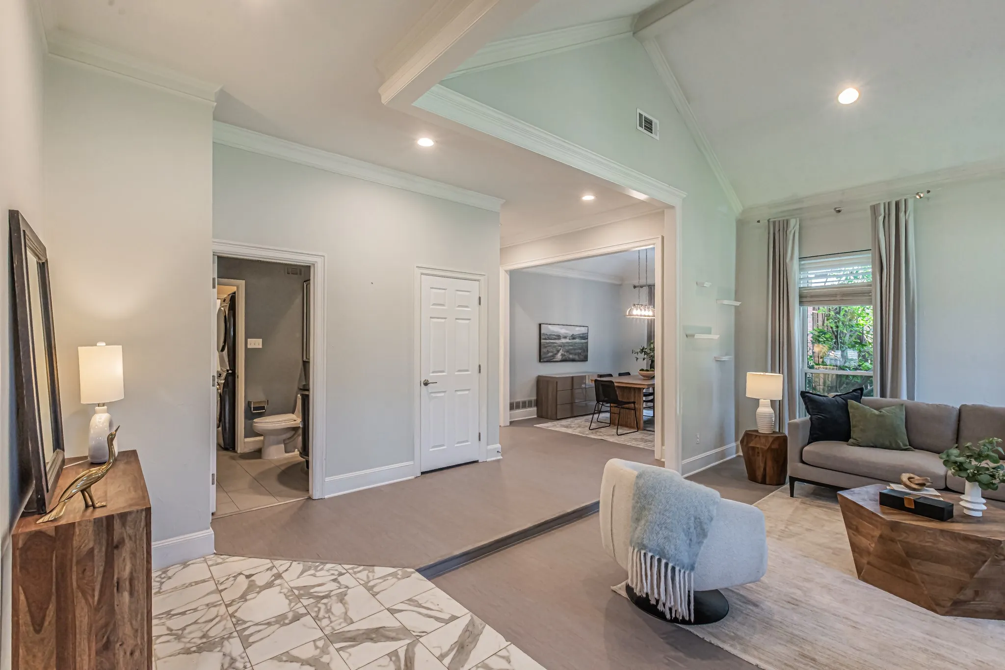 Vaulted ceiling, recessed lighting, wood-finish flooring, white panel doors, and crown molding