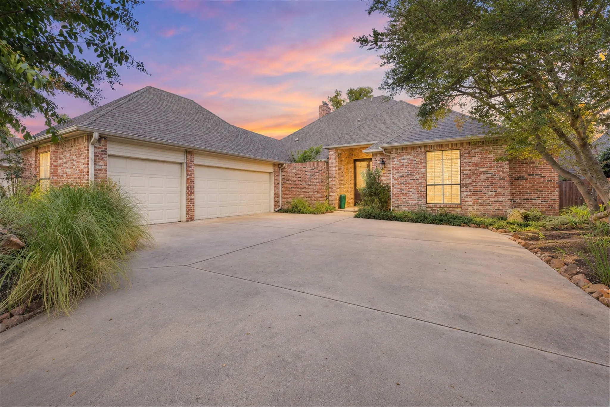 Traditional brick home in Old Shepard Place with a front-entry three-car garage.