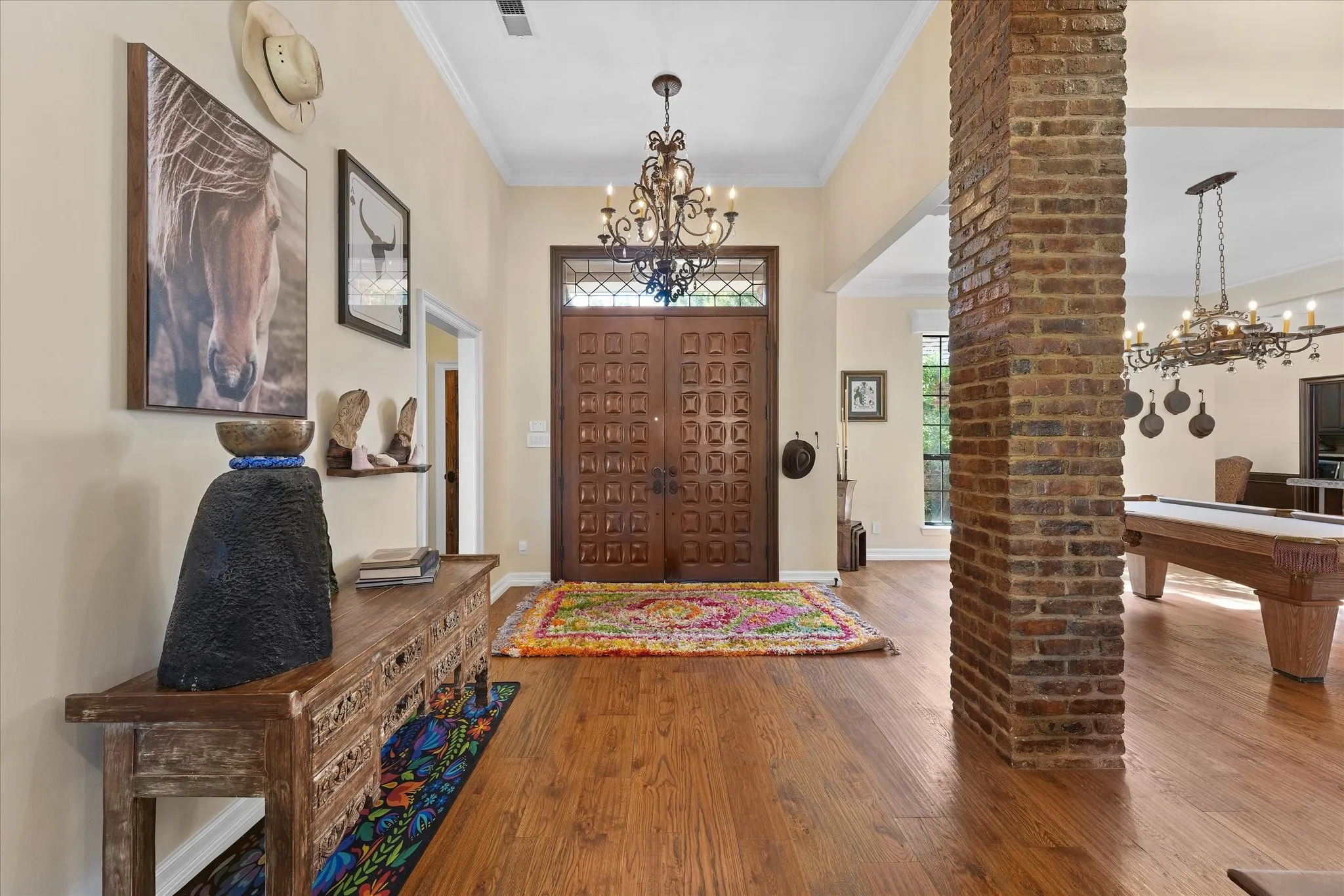 Custom mahogany double entry doors open to the connected main living spaces.