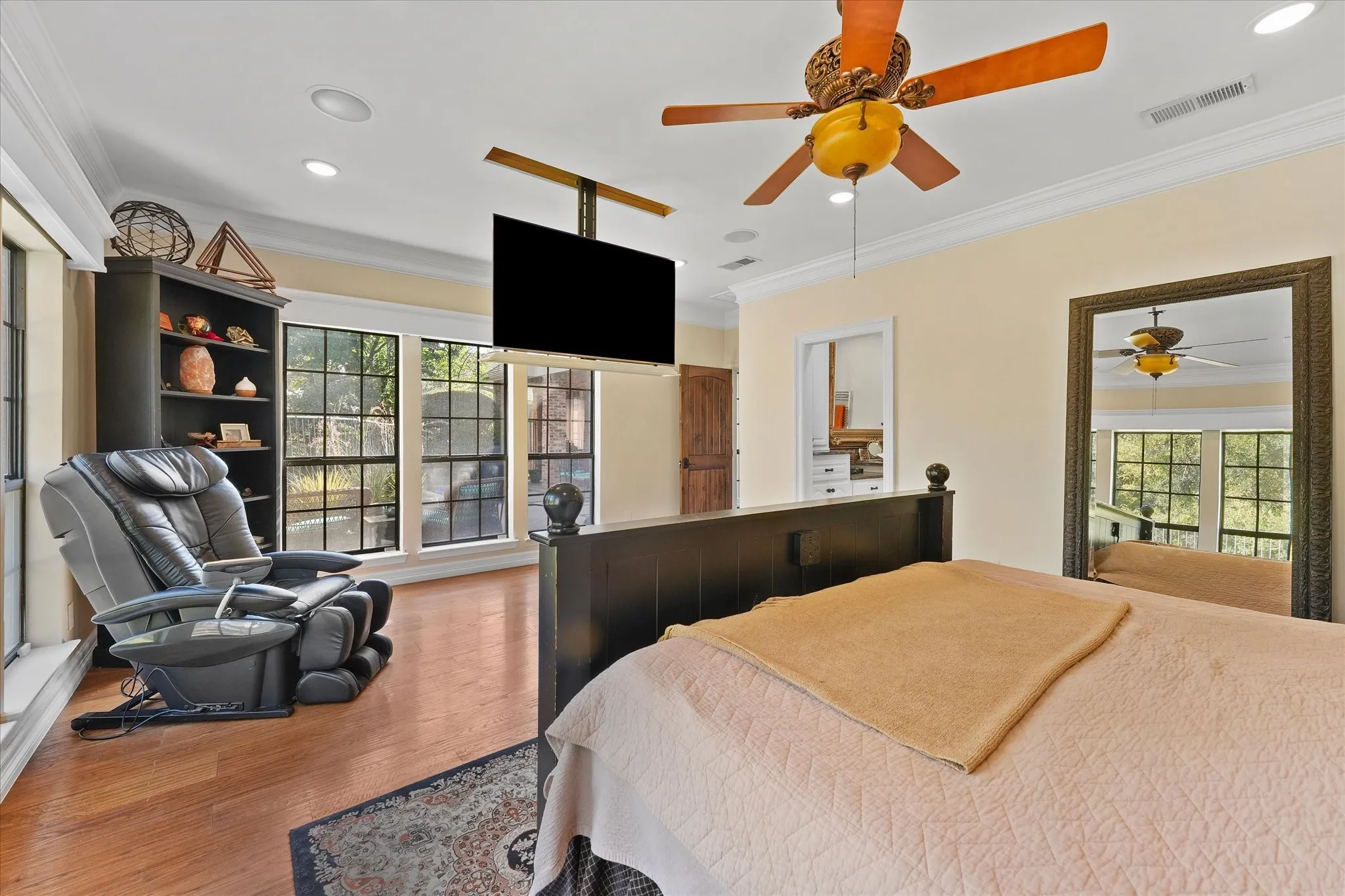 The primary suite includes a ceiling-mounted, drop-down television.