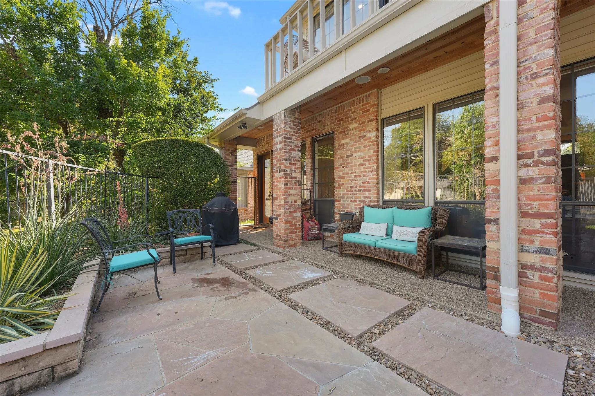 Covered rear patio with a reclaimed-pine ceiling and space to relax outdoors.
