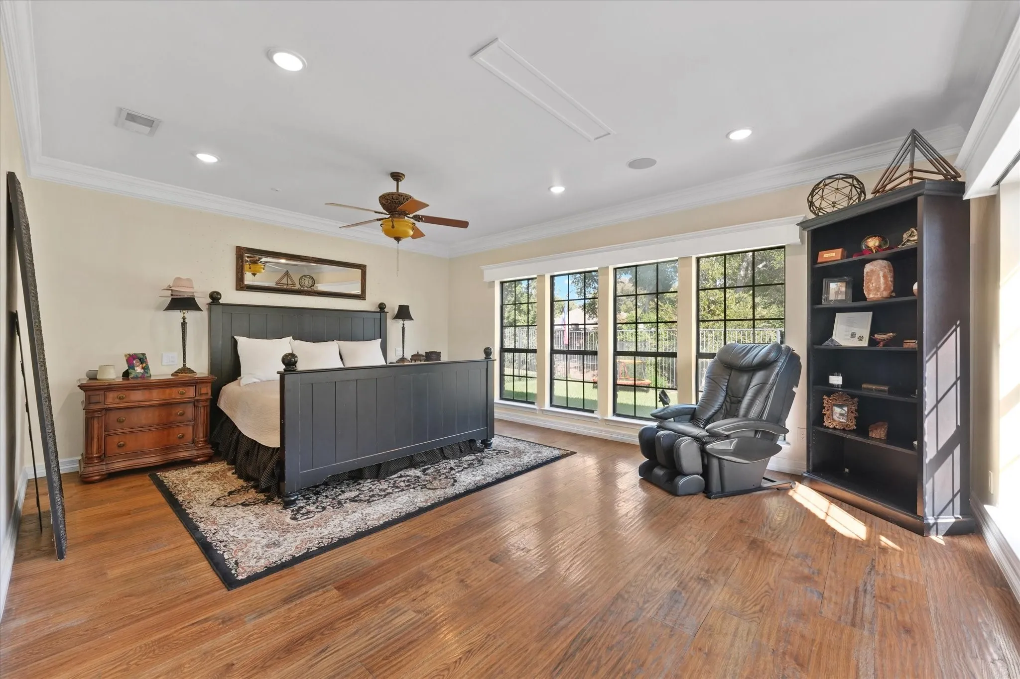 Main-floor primary suite with abundant natural light and space for a sitting area.