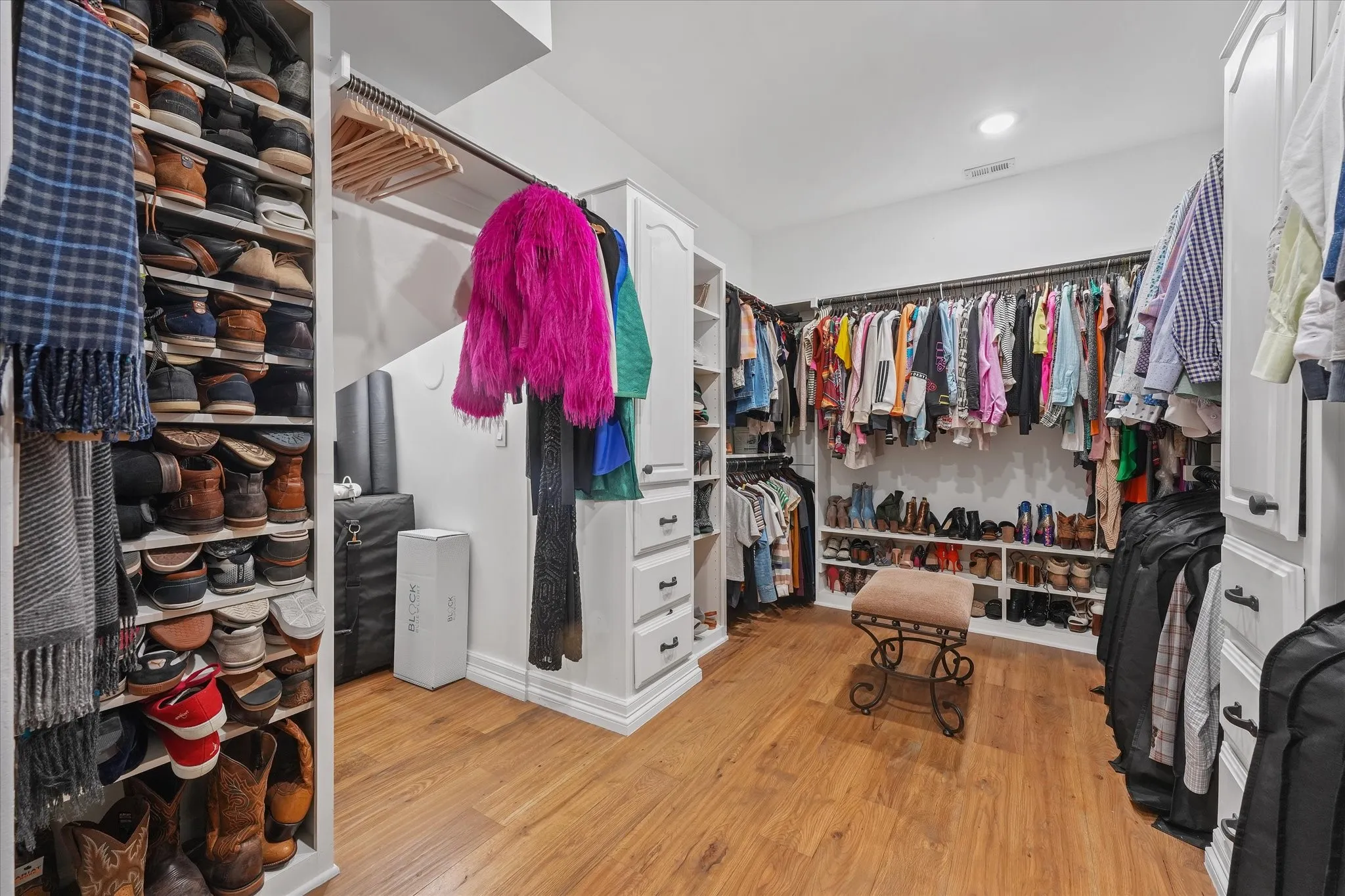 Expanded primary walk-in closet with custom storage.