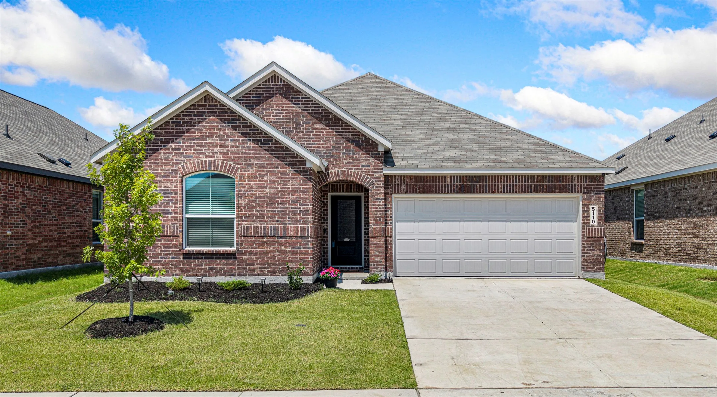 Brick exterior with arched entry and window