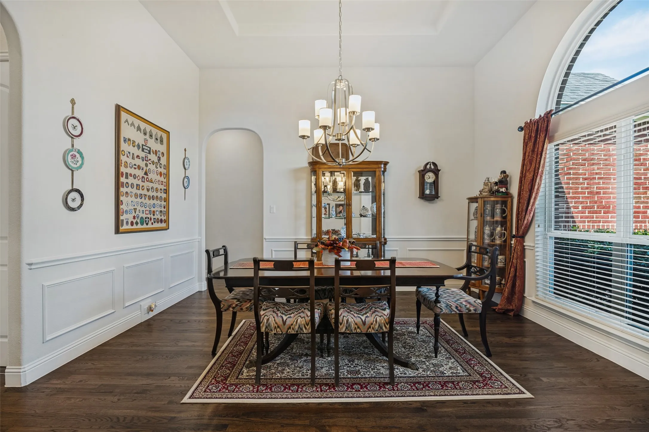 Formal dining with chair rail molding, beautiful chandelier and hardwood floors