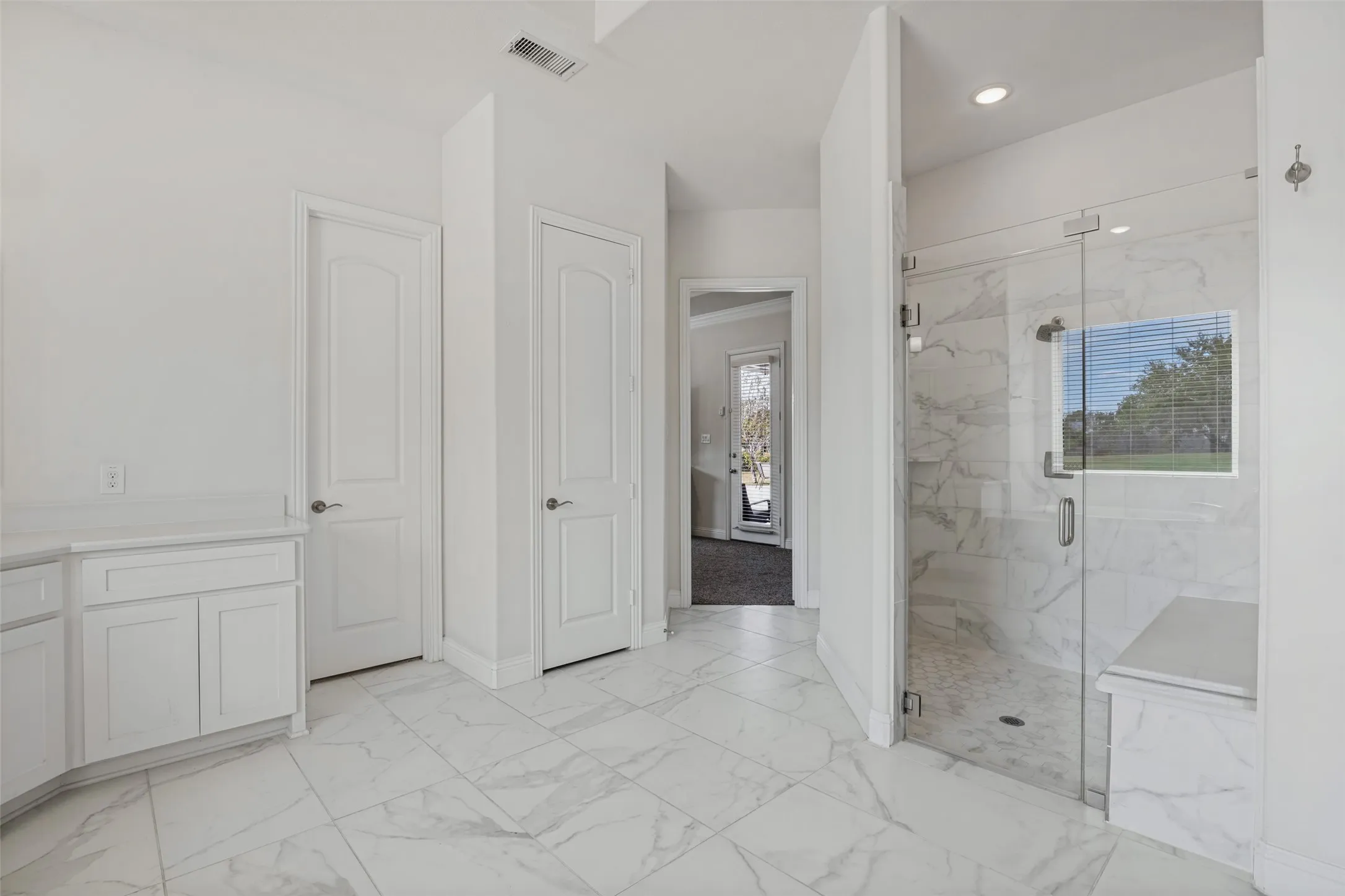 Large Primary bathroom with large separate shower with shower seat and 2 shower heads.