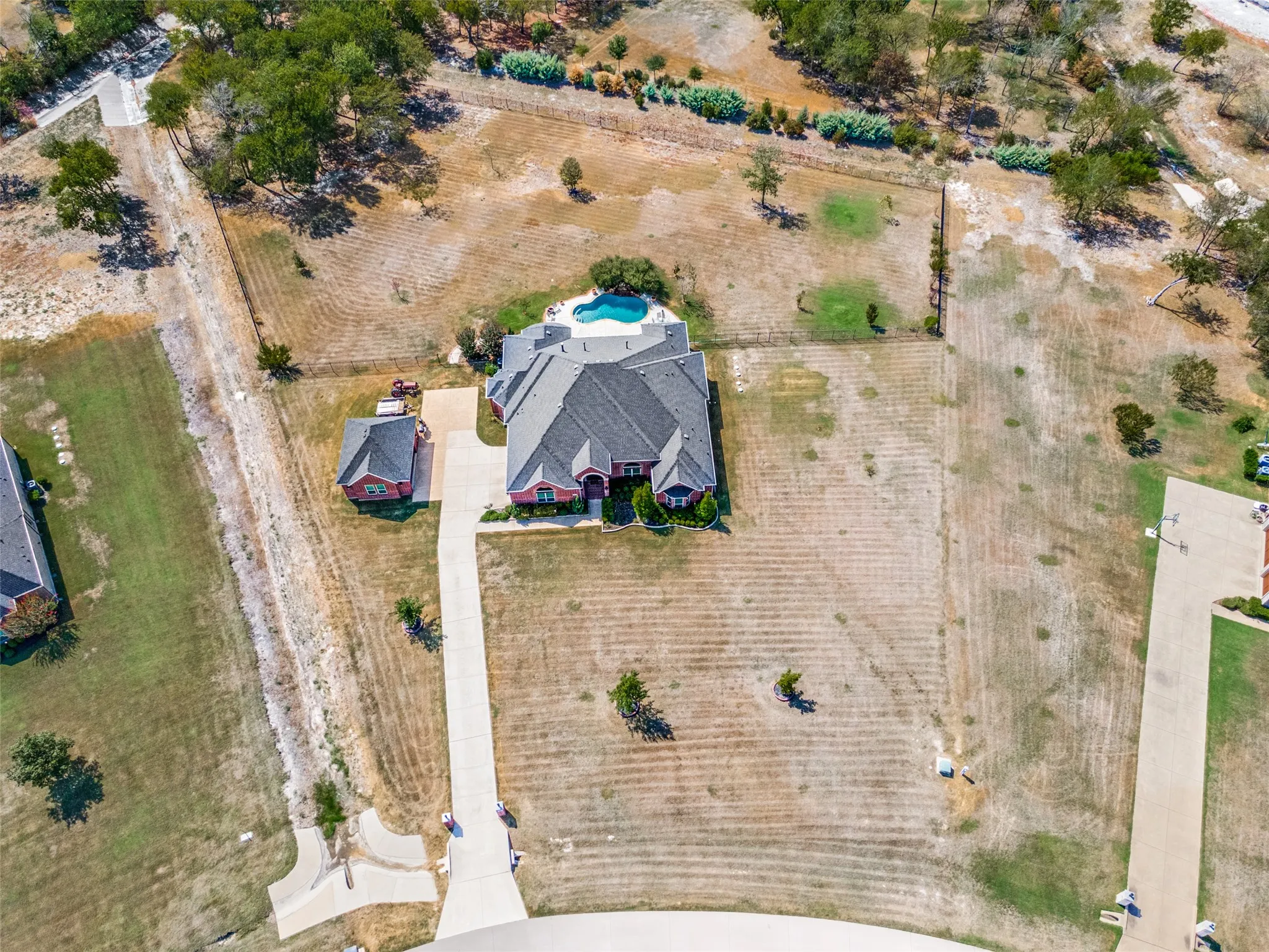 Aerial view of home with large pie shaped lot.