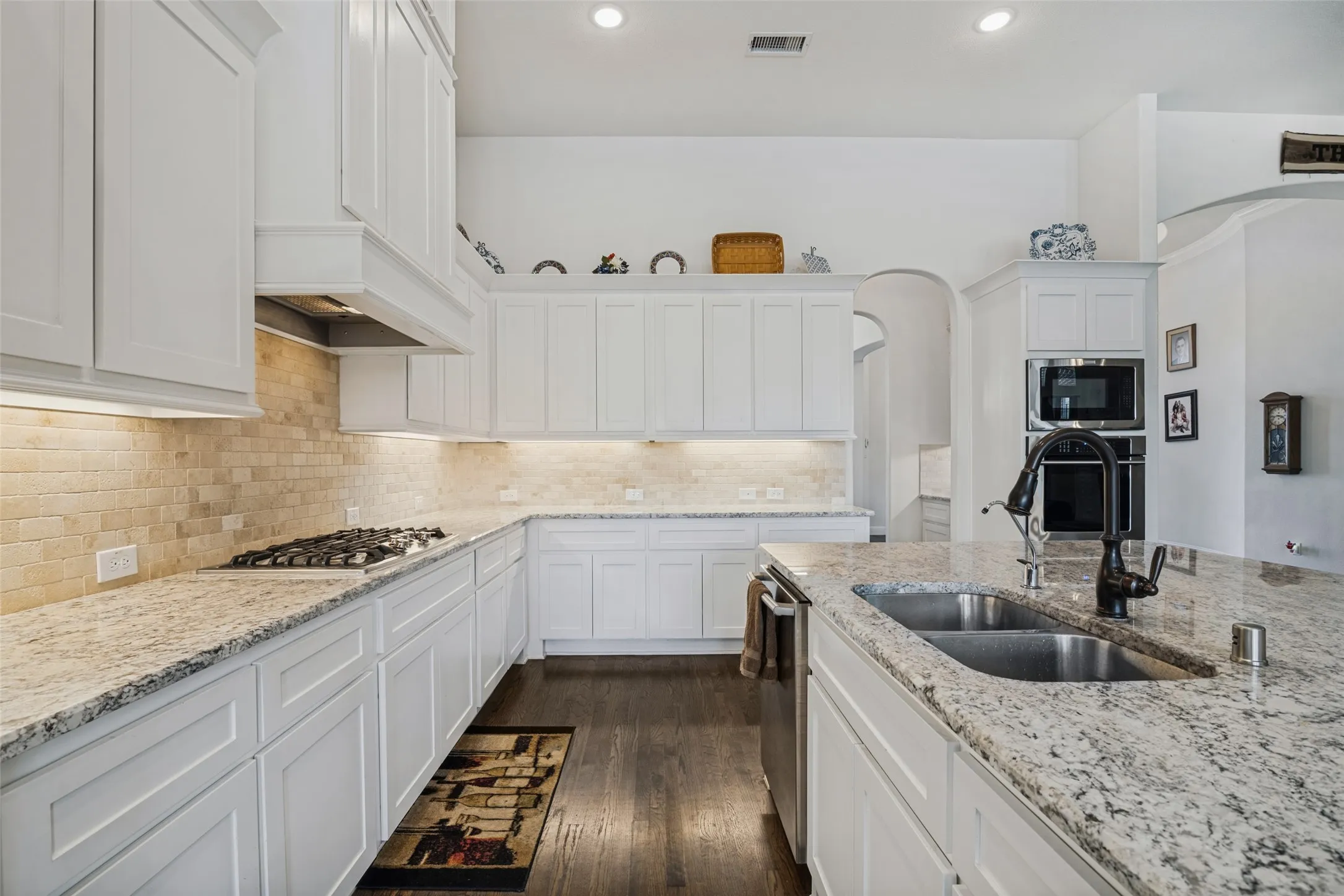 Beautiful kitchen with lots of shaker style cabinets and hardwood floors.