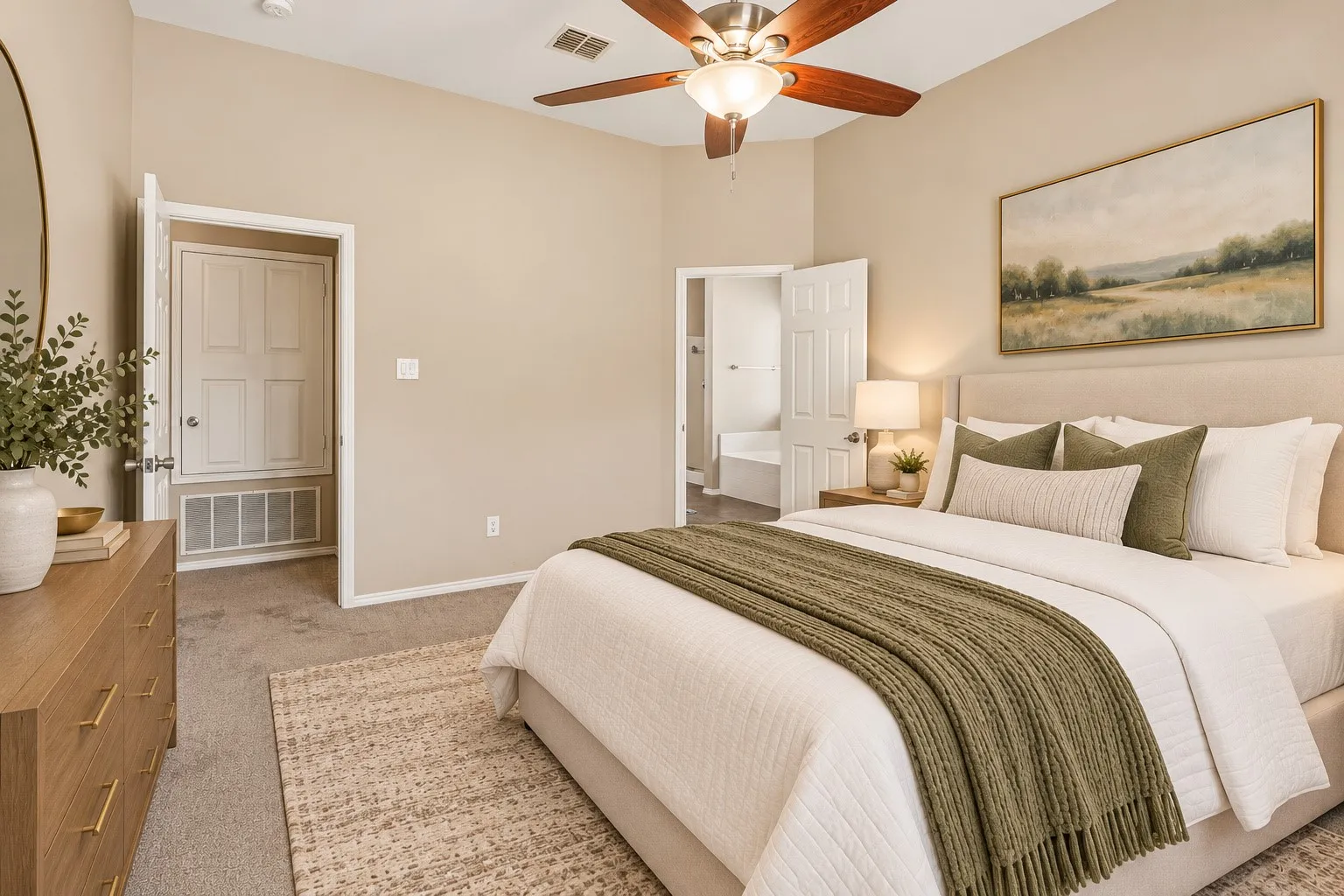 Vaulted ceiling with a wood-finish ceiling fan, upholstered headboard, and beige carpeting