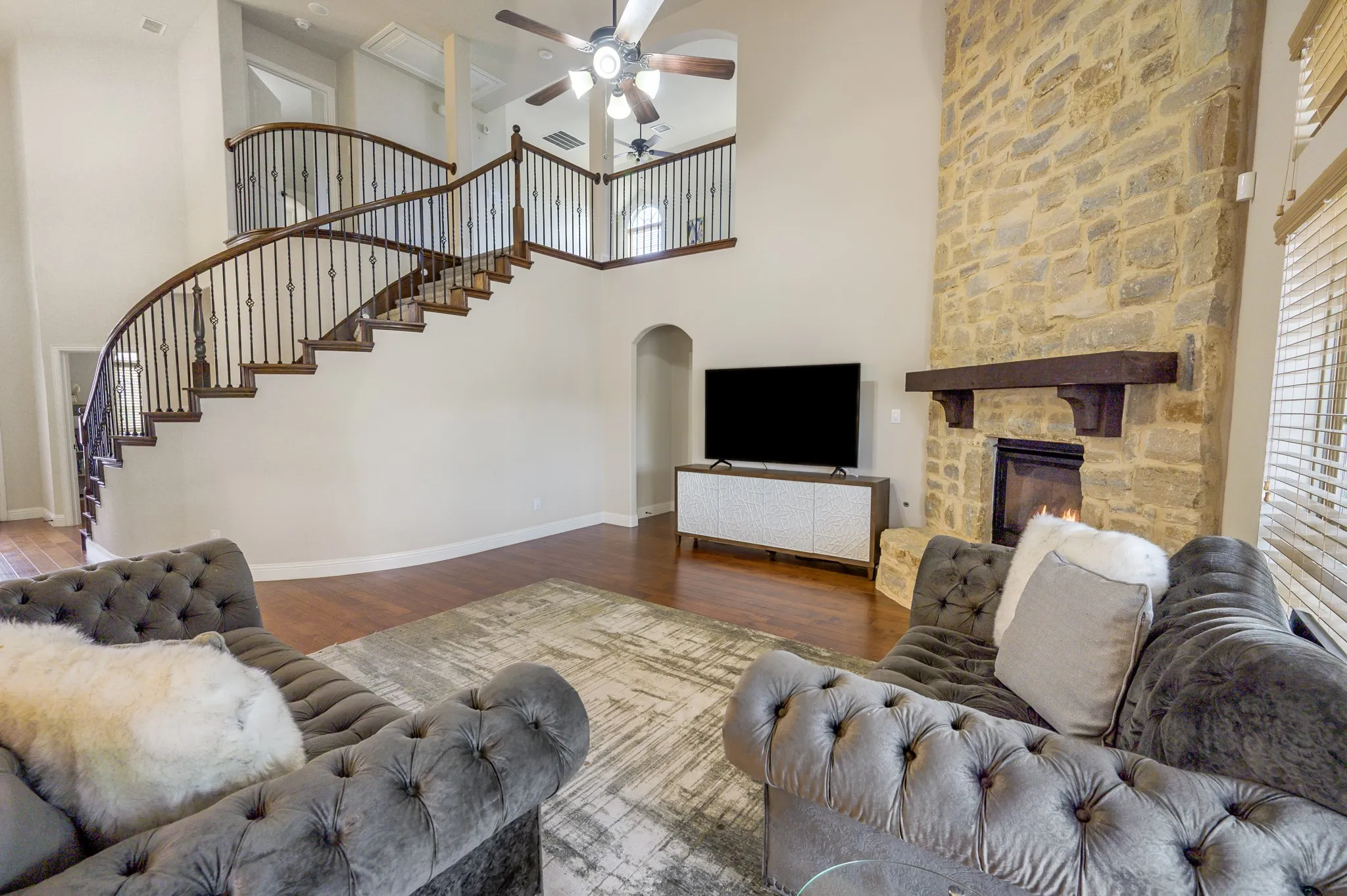 Curved staircase with wood treads and wrought iron balusters