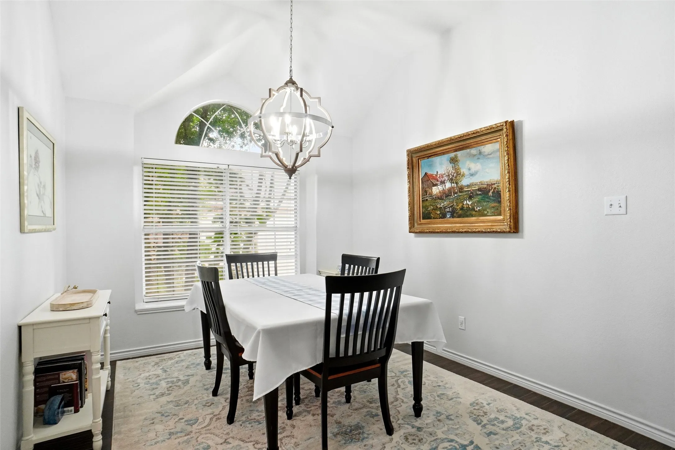 Dining room with natural light adjacent to the living room and kitchen.