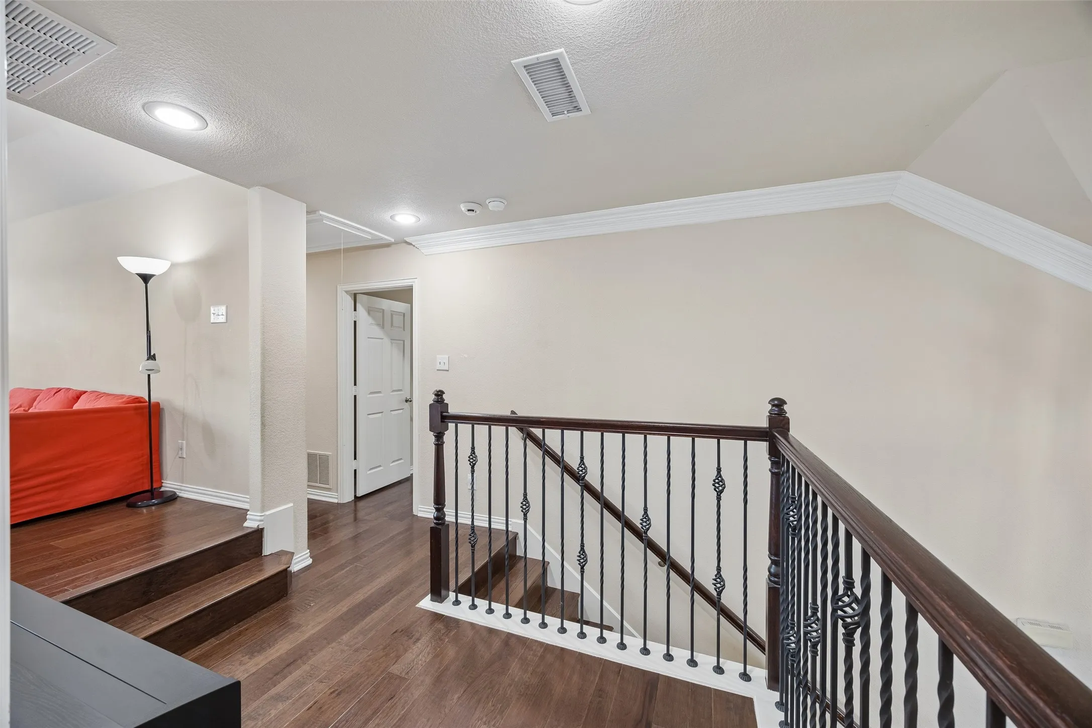 Wood-finish flooring throughout, recessed lighting, and crown molding