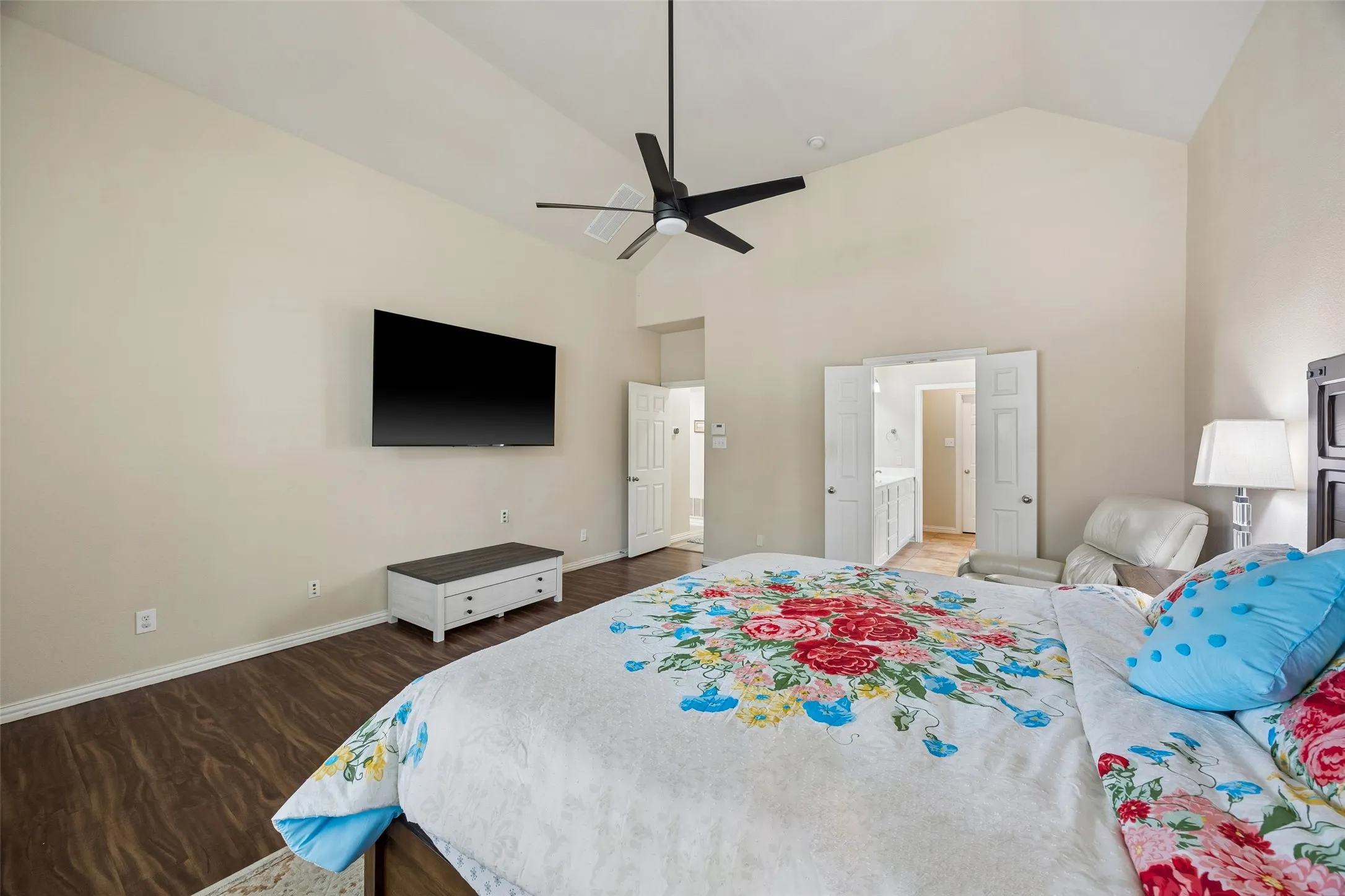 Vaulted ceiling with a ceiling fan, recessed lighting, wood-finish flooring, and double-door entryway