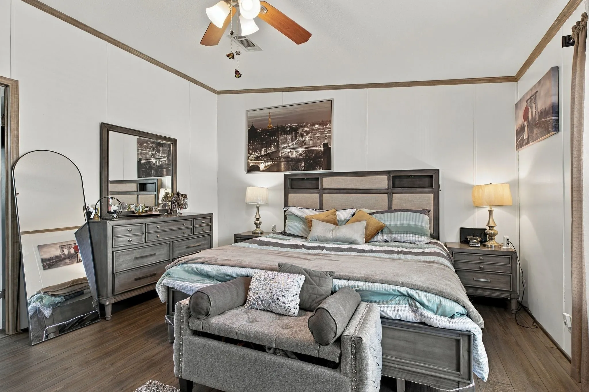 Wood-finish flooring with white paneled walls and brown trim accents