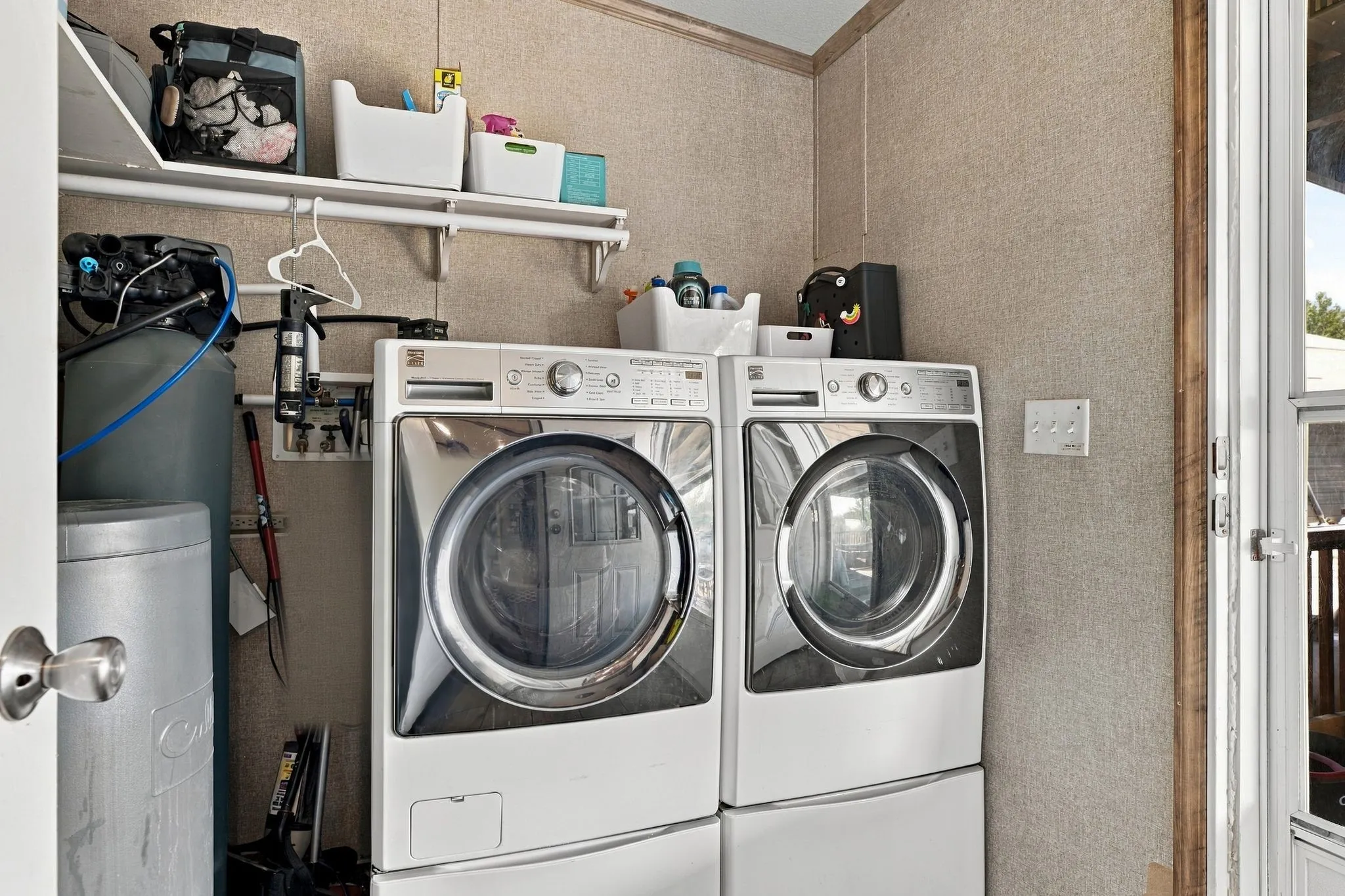 Appliance hookups, built-in shelving, water softener system, and textured wall finish
