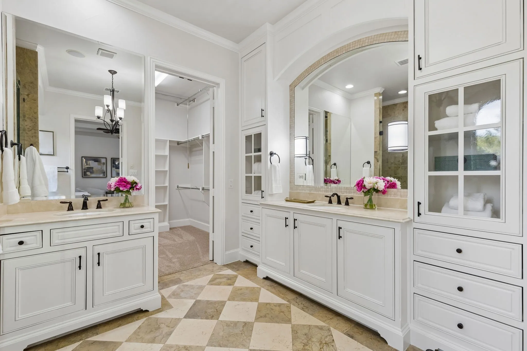 Primary bathroom with his and hers sinks, accompanied by beautiful and functional cabinetry