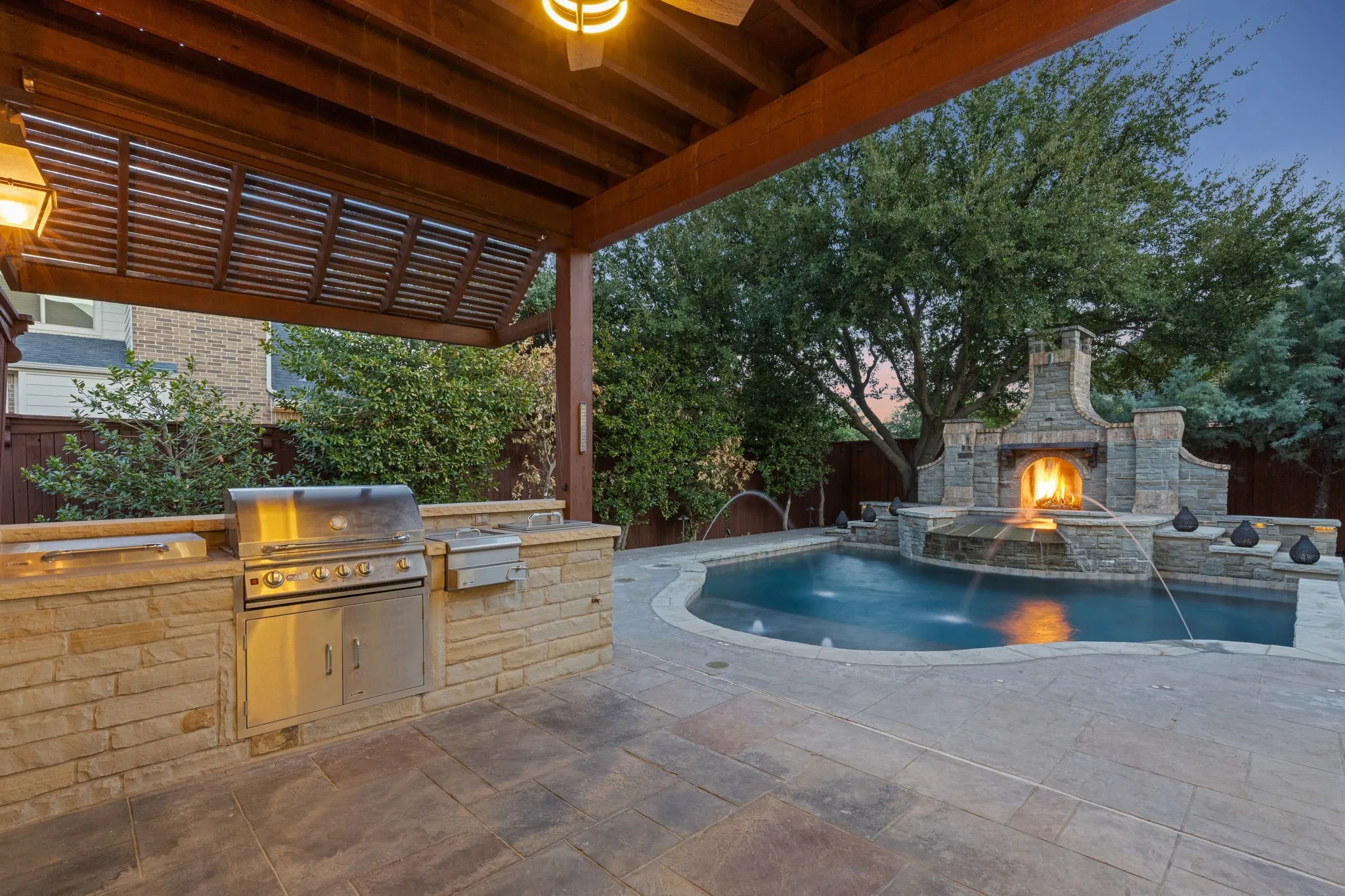 Gorgeous patio with outdoor kitchen overlooking the pool