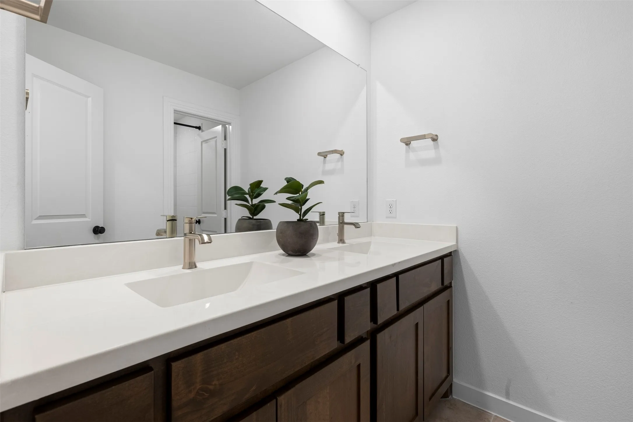 Dual undermount sinks with brushed nickel faucets, set in a white solid surface countertop