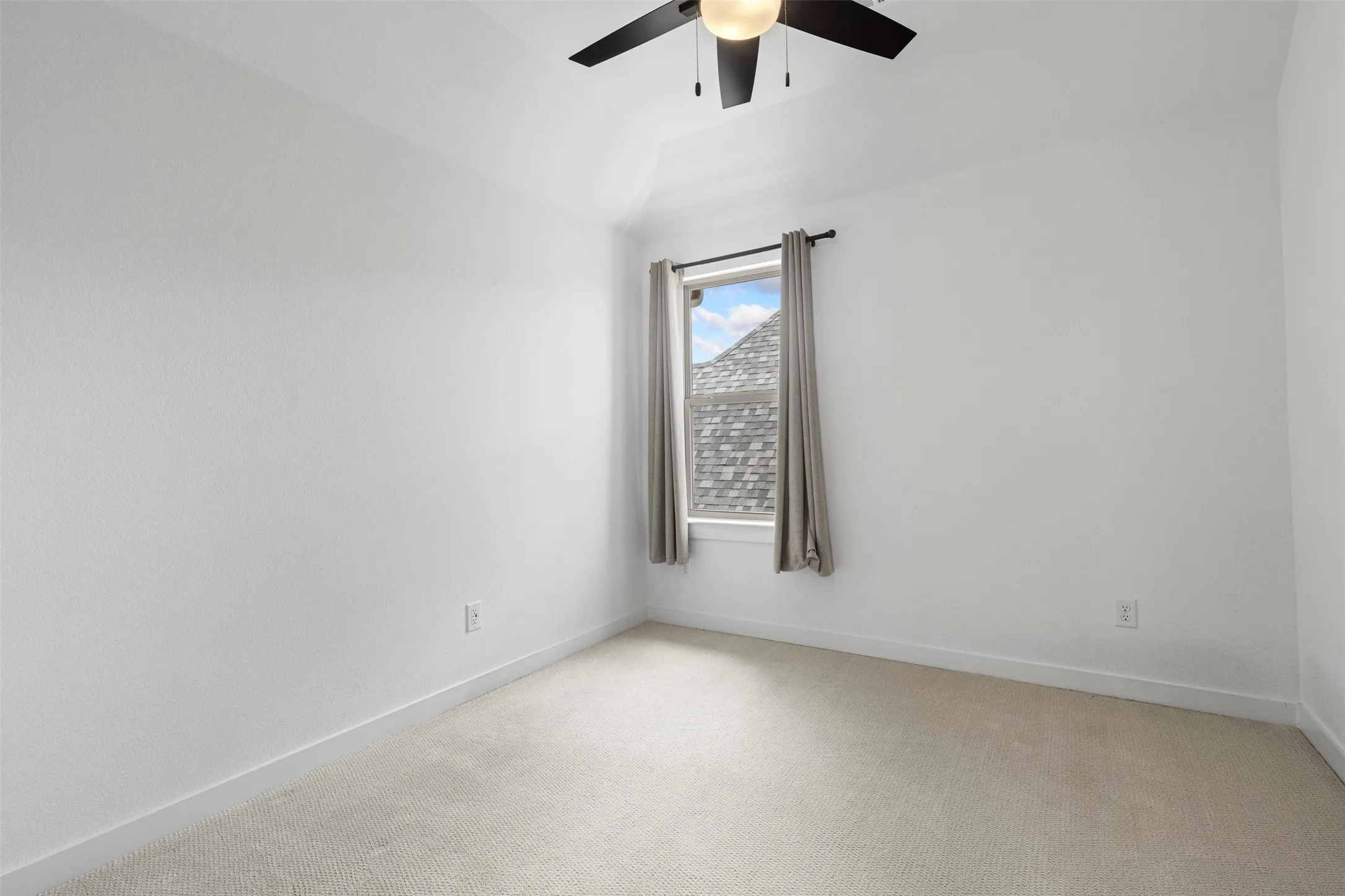Recessed window with white trim, vaulted ceiling, and ceiling fan