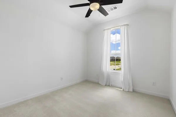 Vaulted ceiling with a ceiling fan, carpeted flooring, and a single window