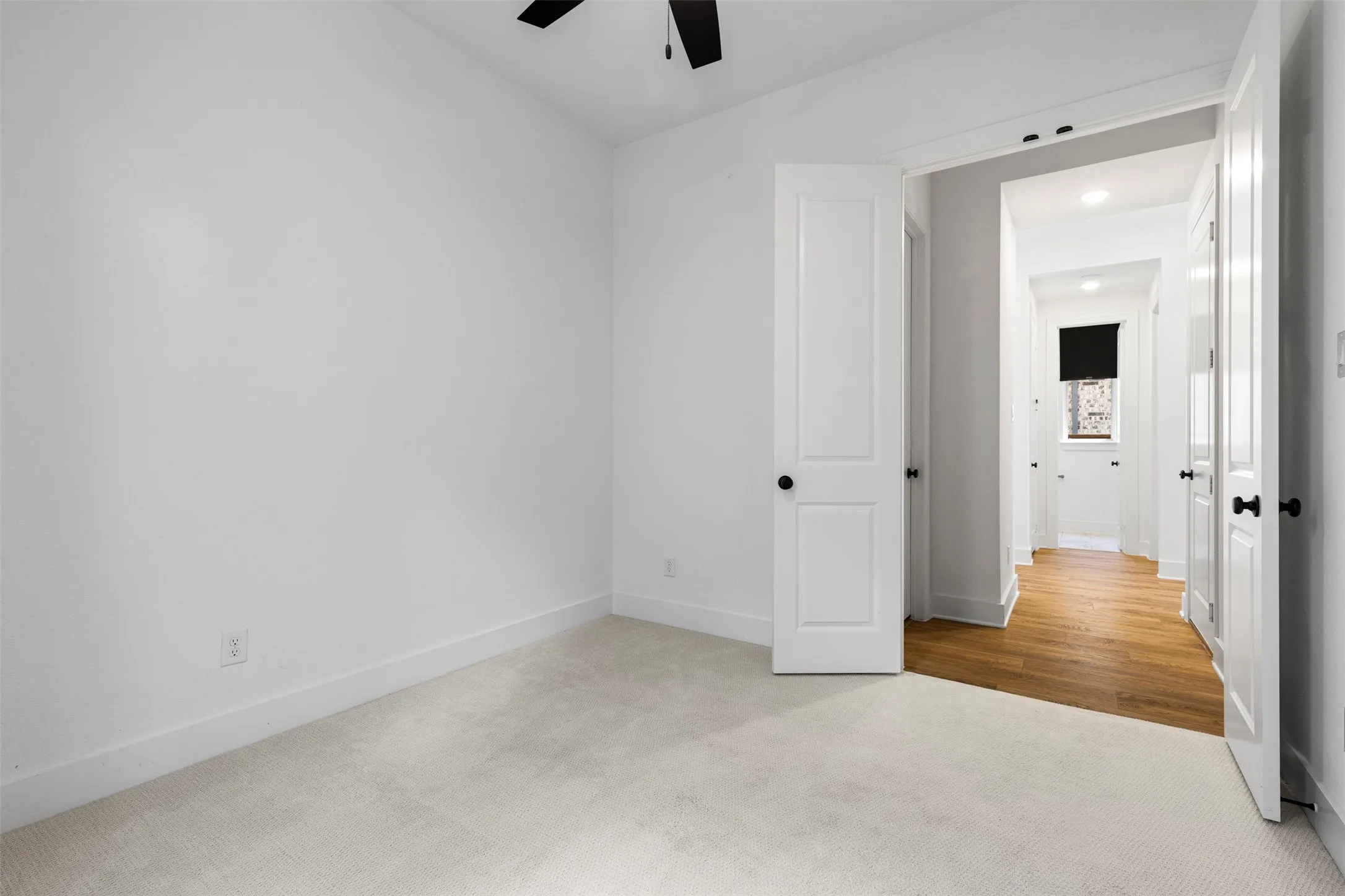 Plush carpet flooring, white walls, white trim, recessed lighting, and a black ceiling fan