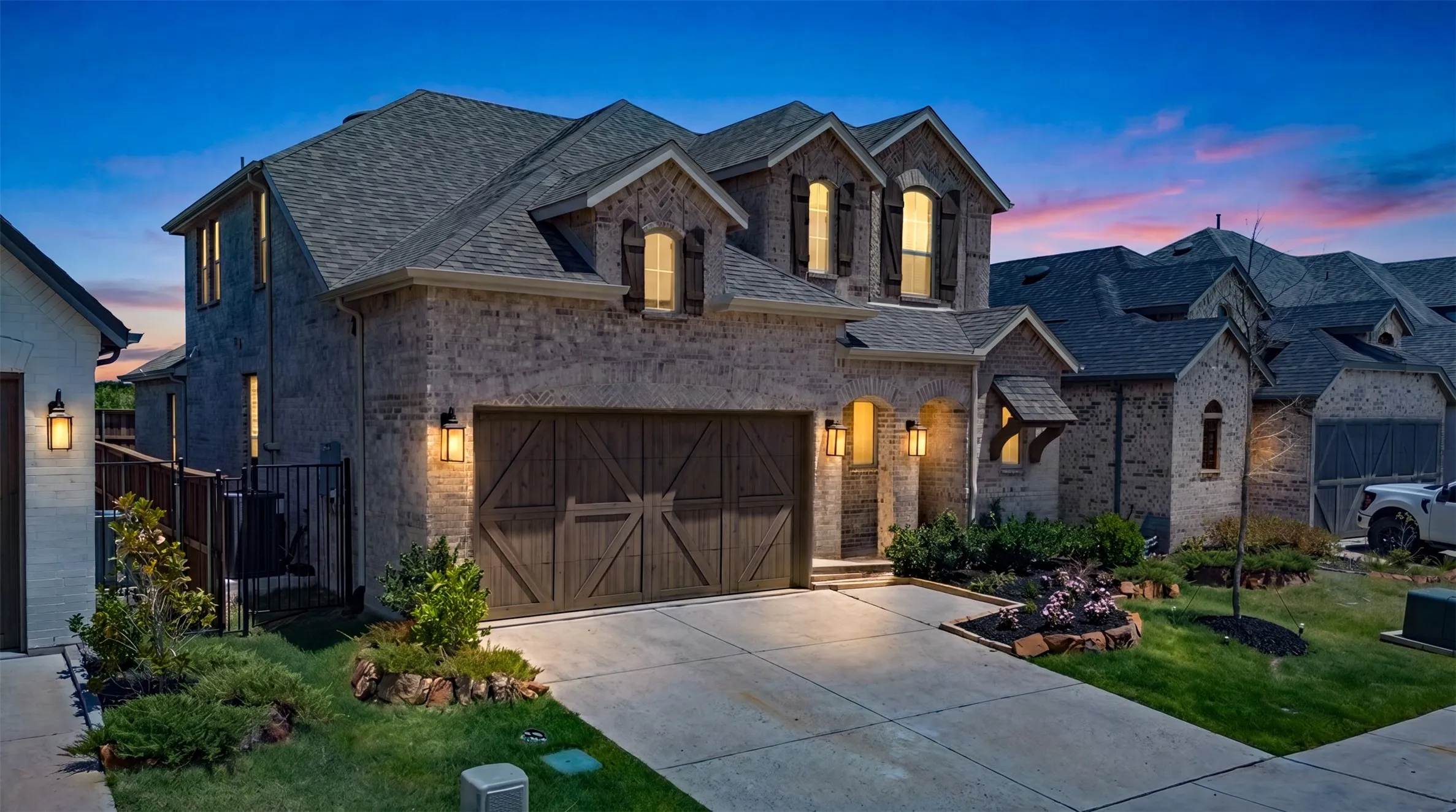 Stone veneer exterior with dark shingle roofing