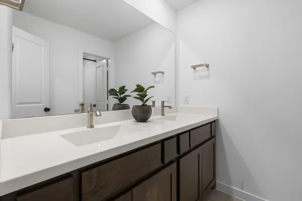 Dual undermount sinks with brushed nickel faucets, set in a light-toned countertop