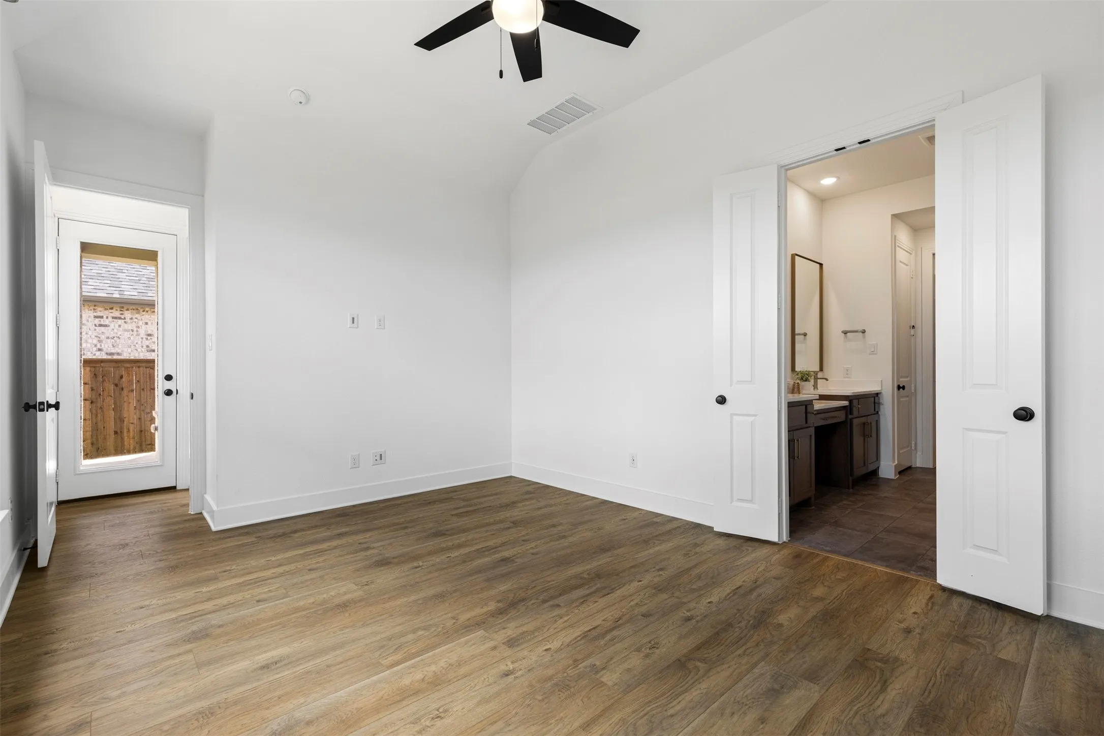 Wood-finish flooring with white walls and trim