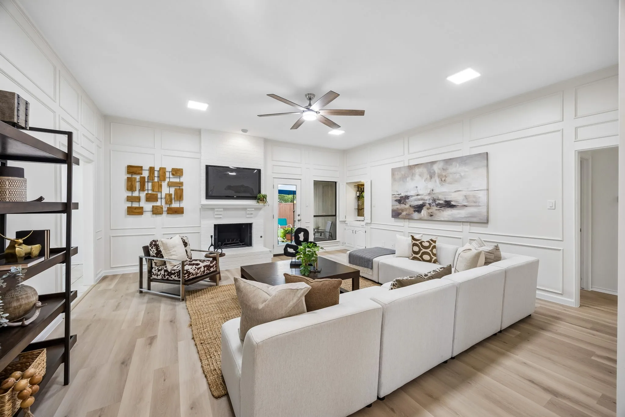 Open concept living space featuring wood-finish flooring and a ceiling fan