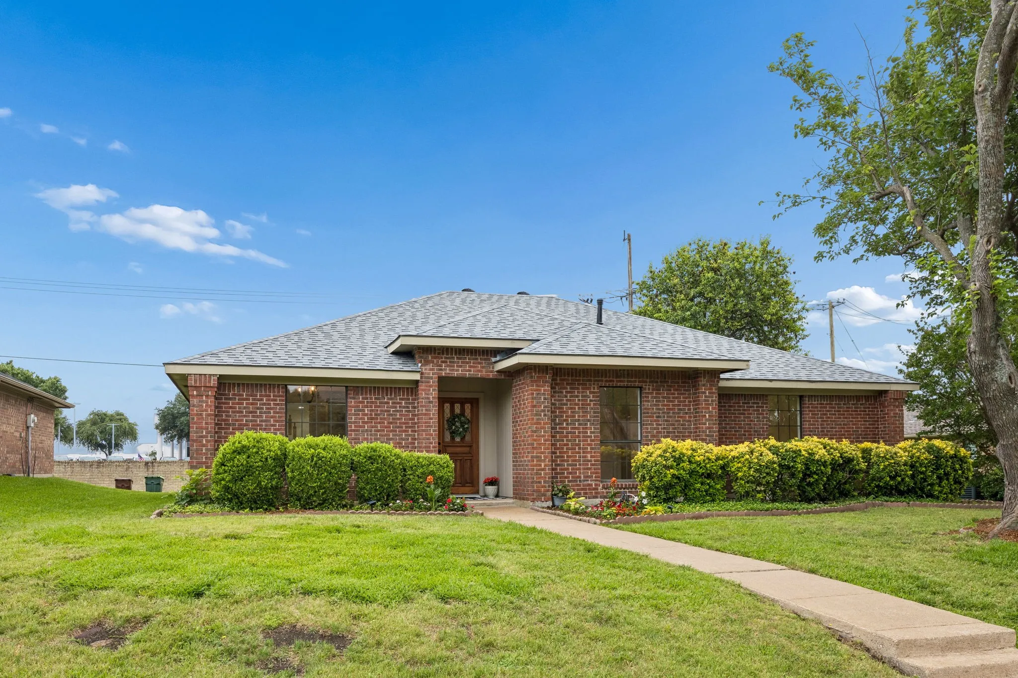 Red brick exterior with a grey shingle roof