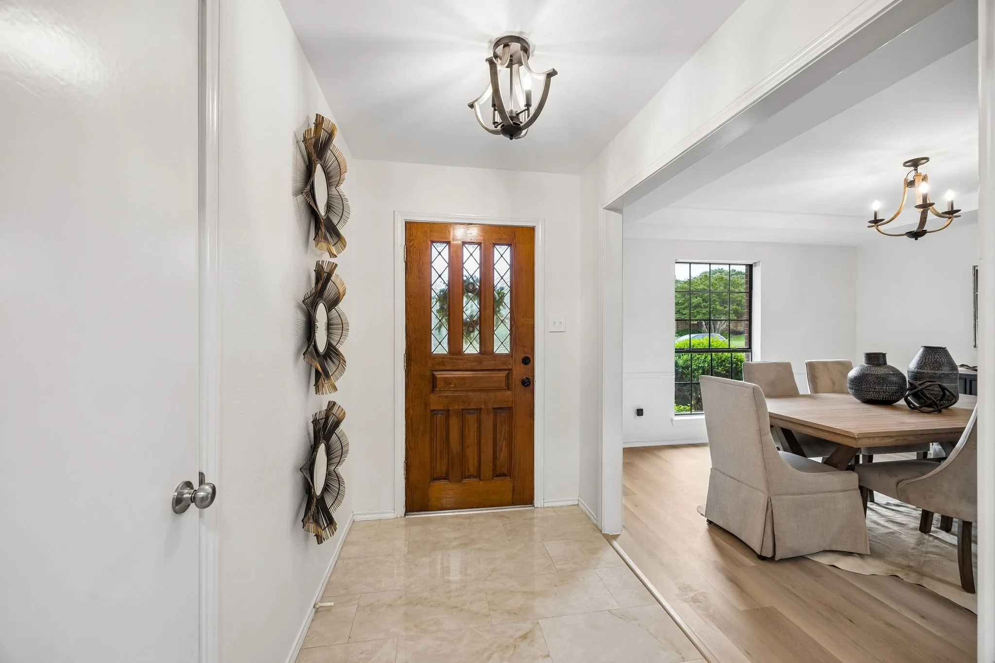 Warm wood-paneled entry door with leaded glass accents