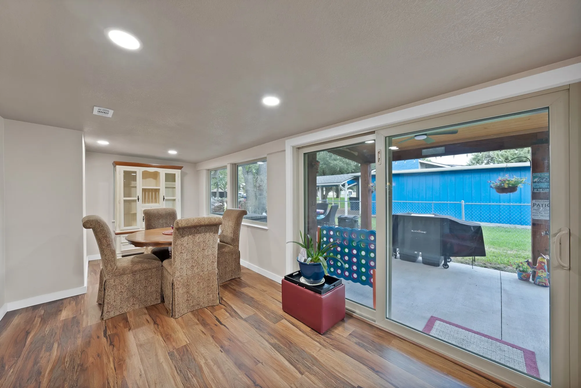 Wood-finish flooring throughout, recessed lighting, and a built-in display cabinet