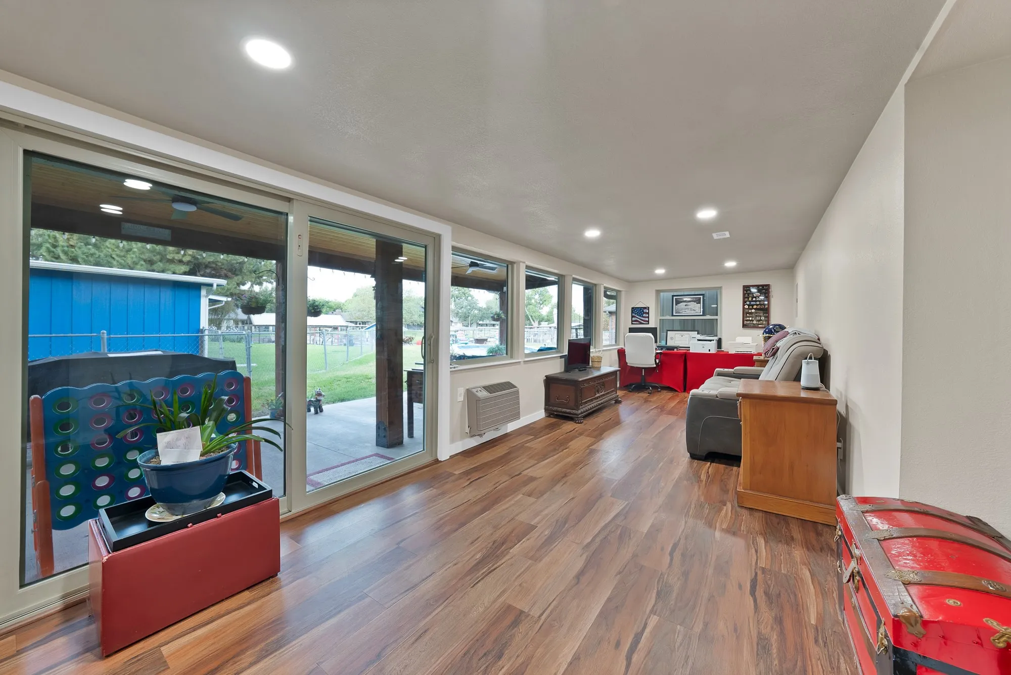 Wood-finish flooring, recessed lighting, and expansive glass sliding doors