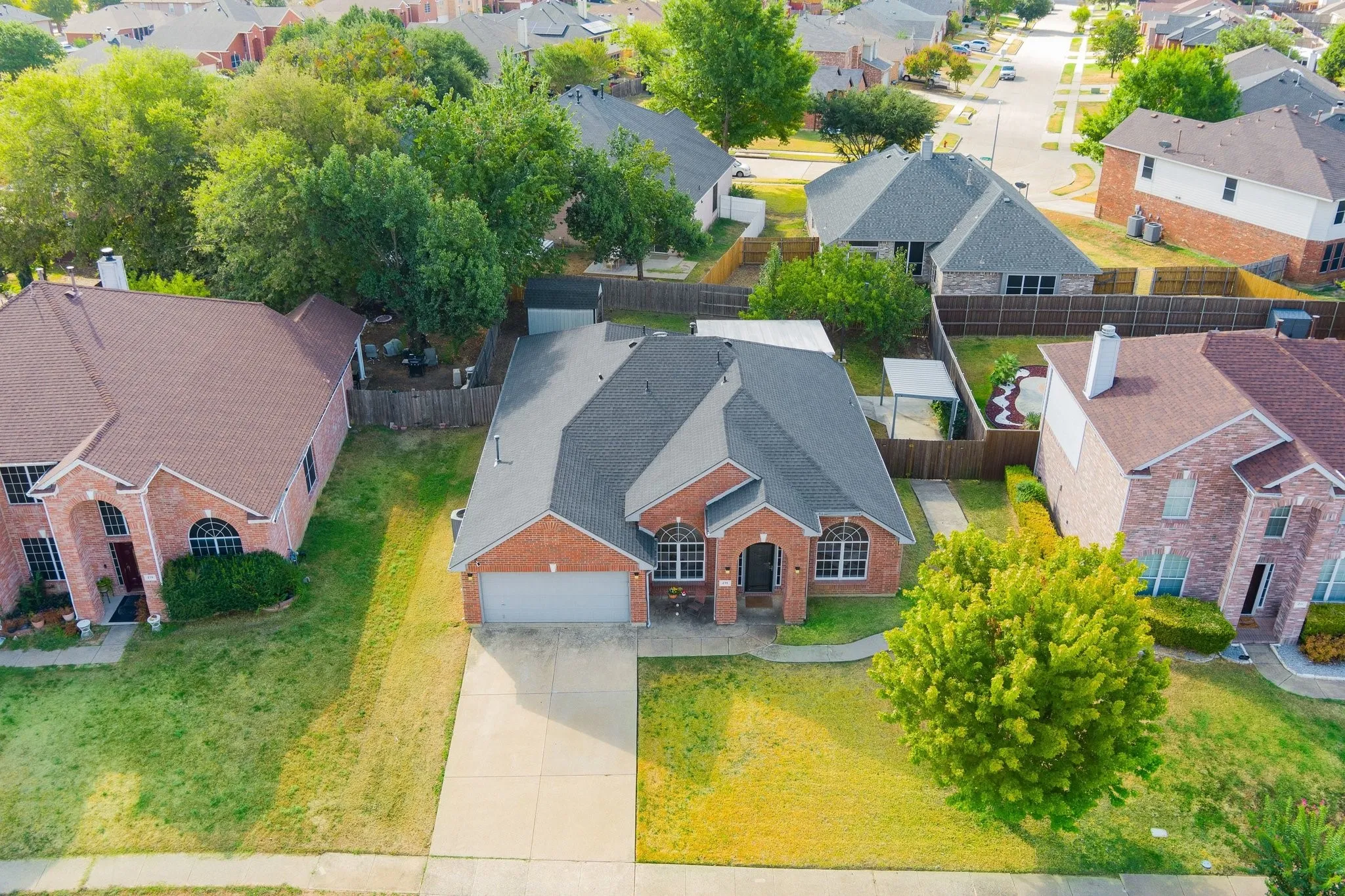 Brick exterior with a dark-shingle roof