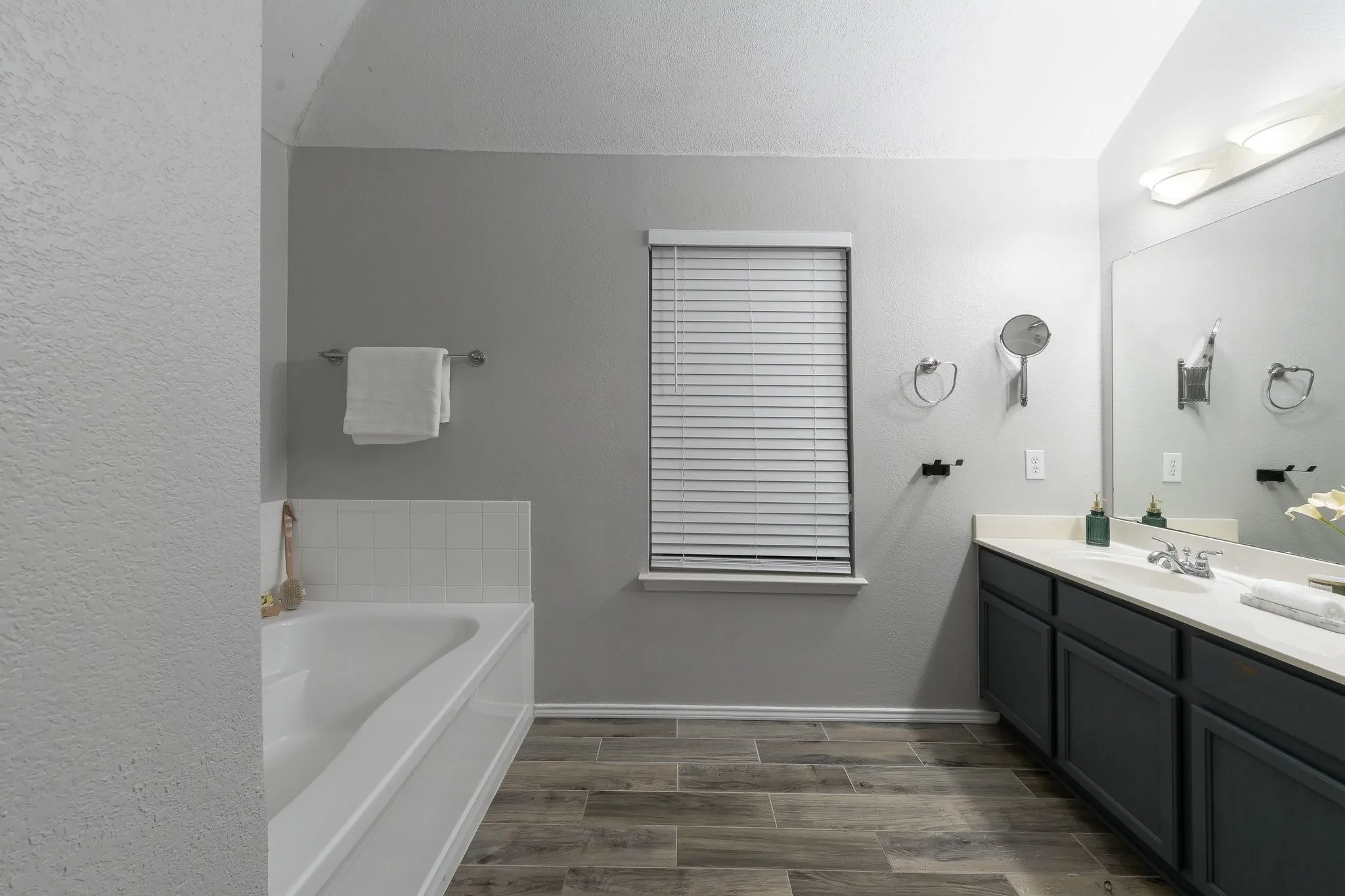 Deep soaking tub with subway tile surround