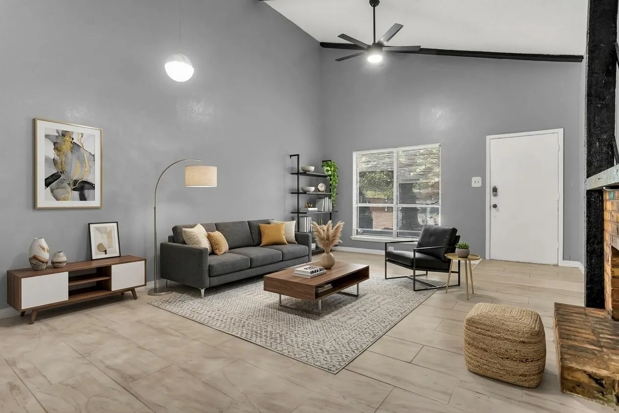 Vaulted ceilings, exposed wood beams, and a brick fireplace