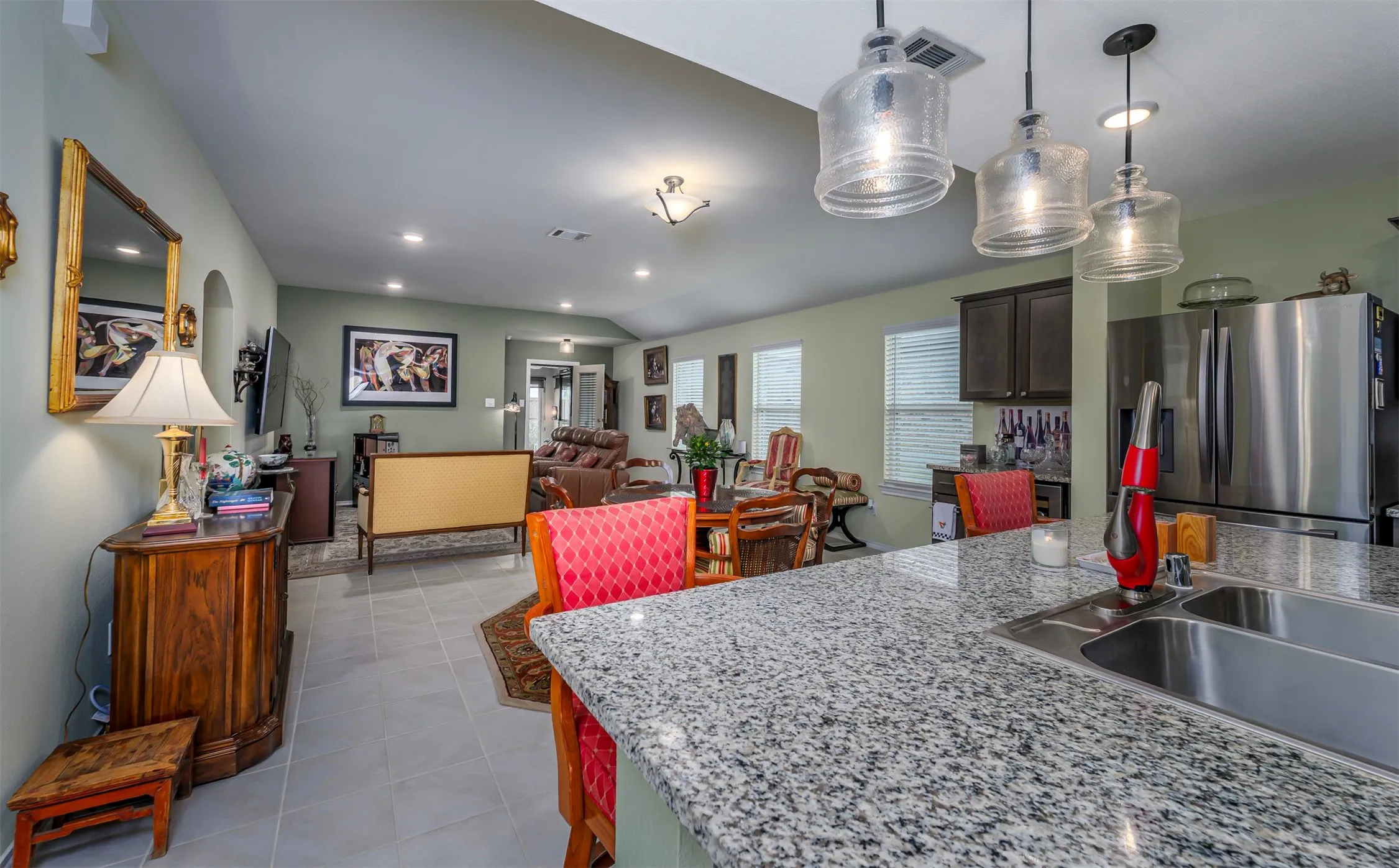 Kitchen island with a granite countertop and an undermount double-basin sink