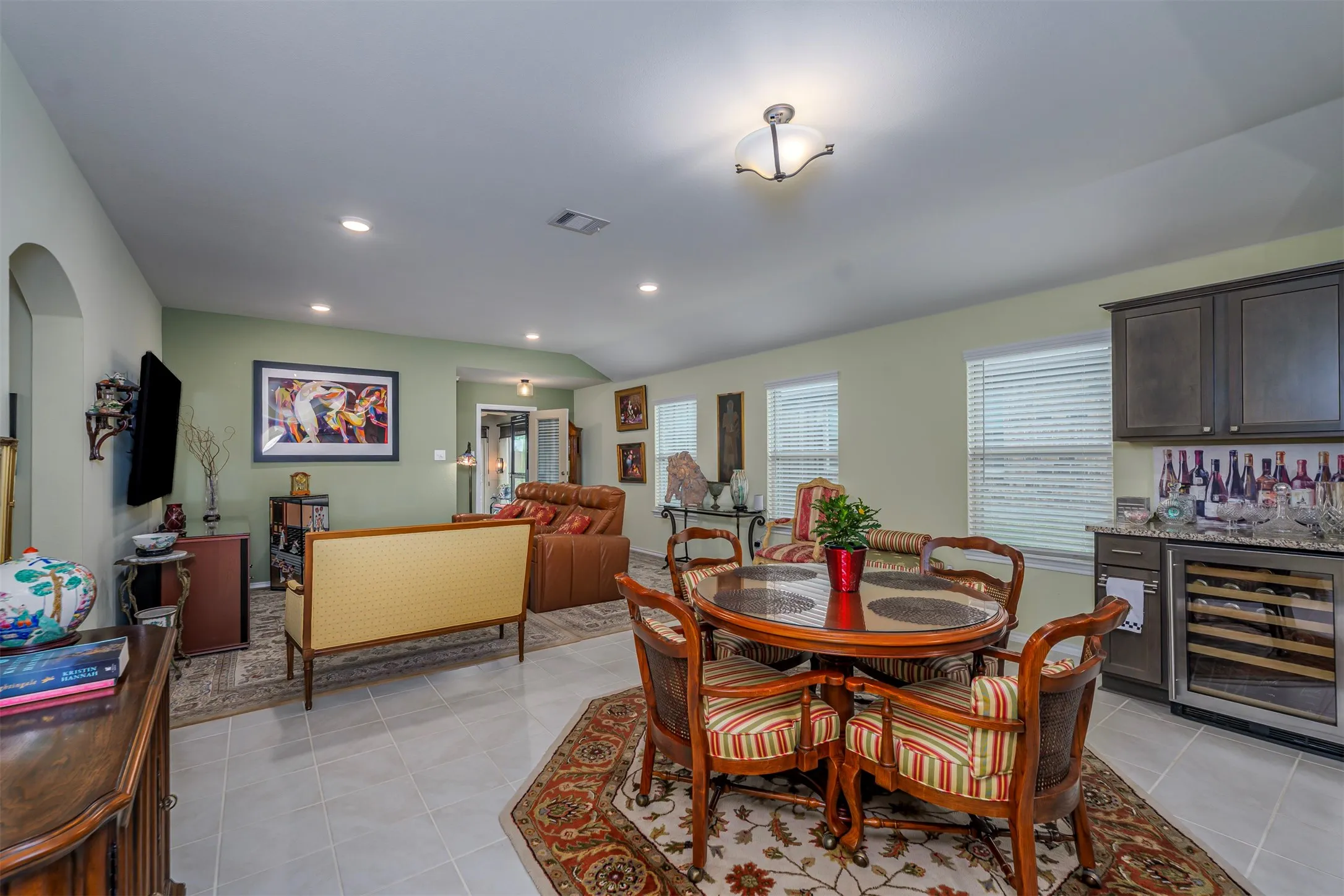 Open-concept living area with tile flooring and recessed lighting