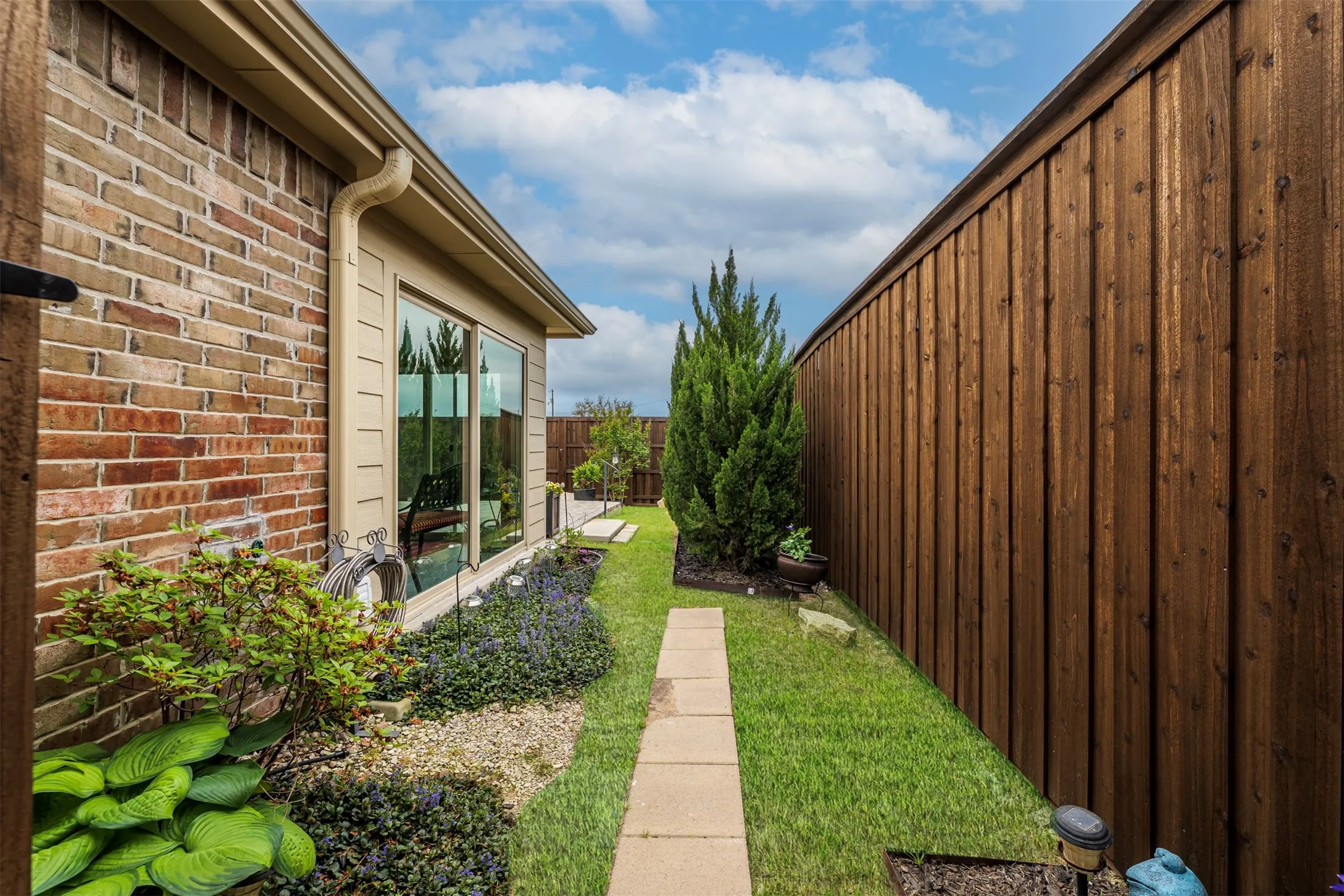 Brick exterior with tan trim and gutters