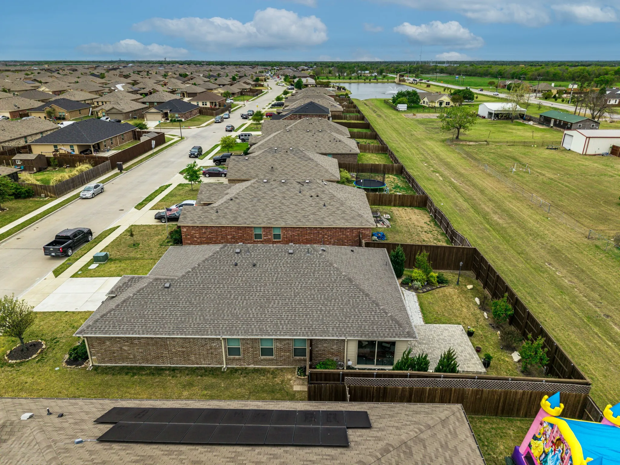 Aerial perspective showcasing residential neighborhood with uniform rooflines and brick exteriors