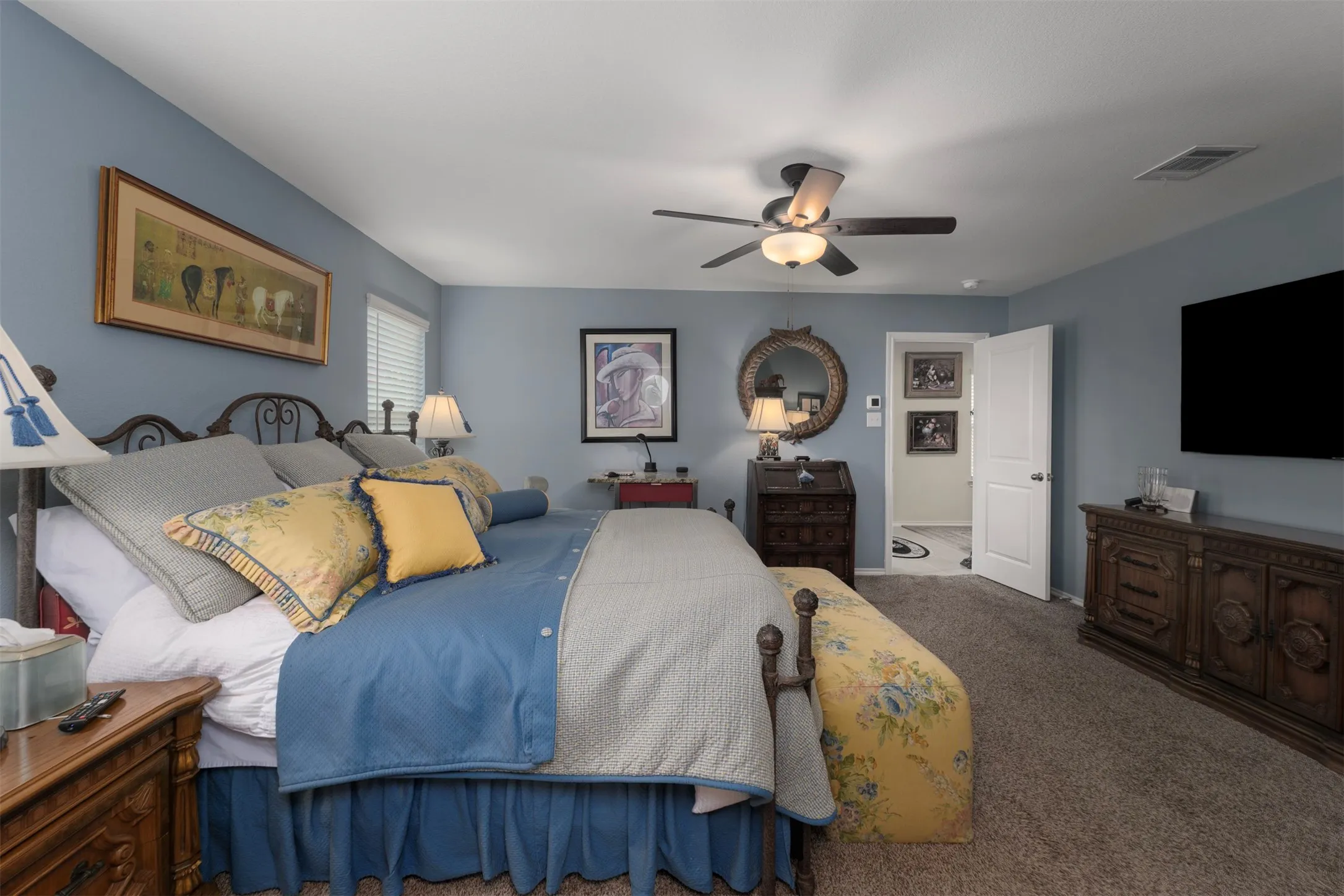 Ceiling fan with integrated lighting, carpet flooring, a white interior door, and window blinds