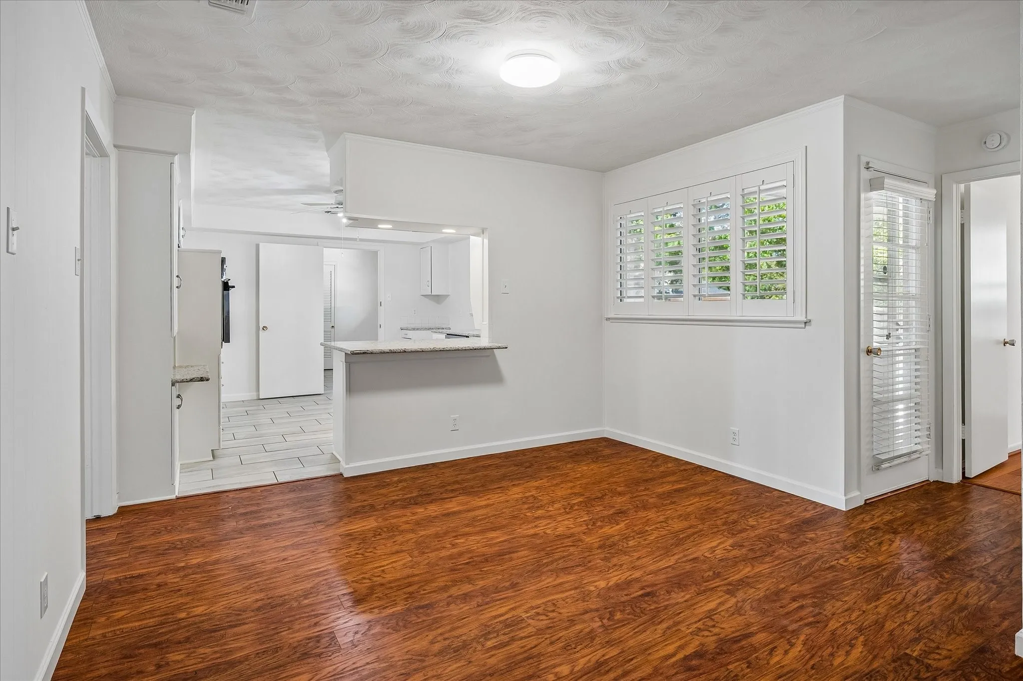 Natural light with white walls and a pass-through kitchen opening