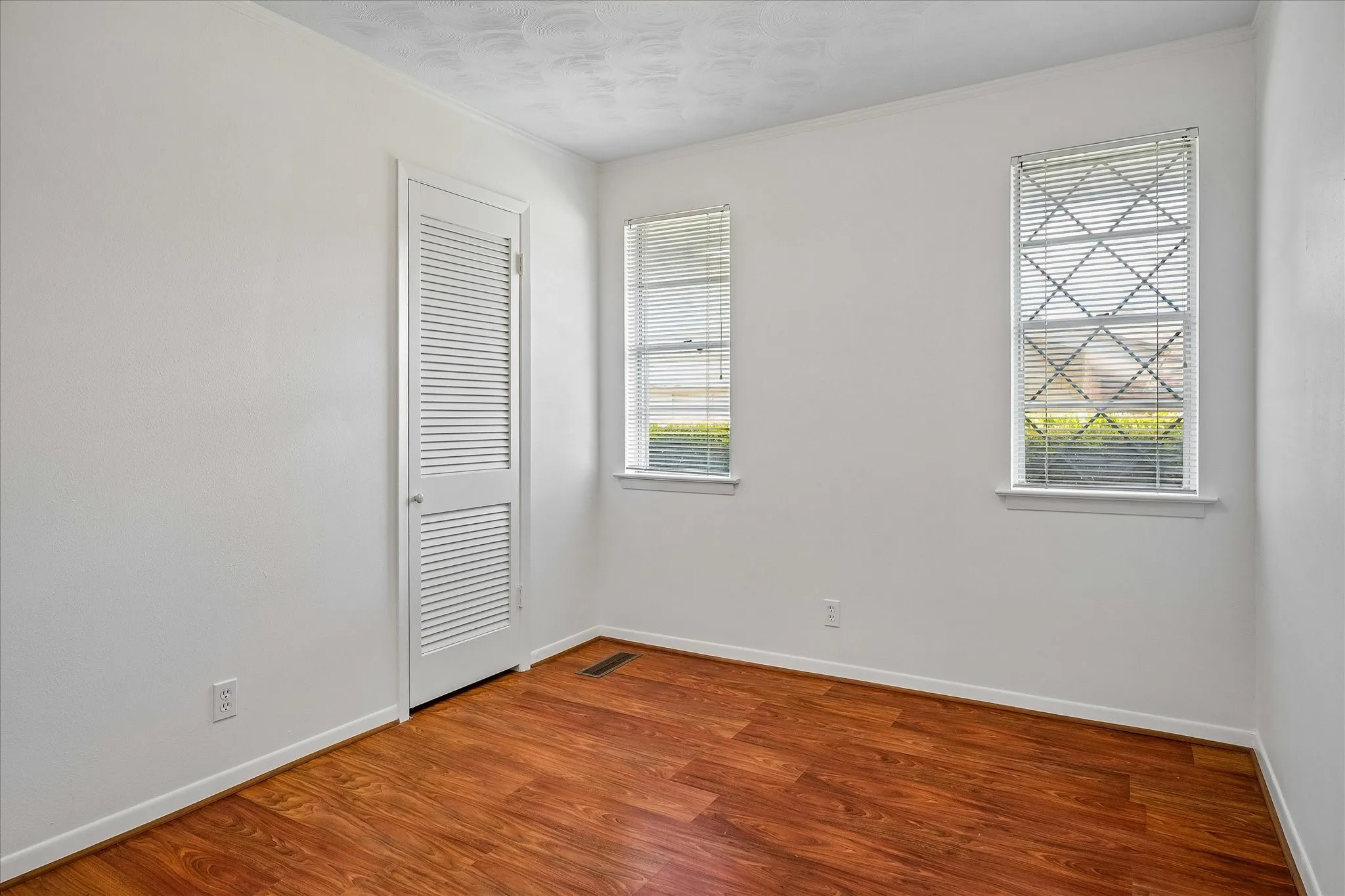 Love this middle bedroom space which has a myriad of different uses. Neutral walls and white louvered door