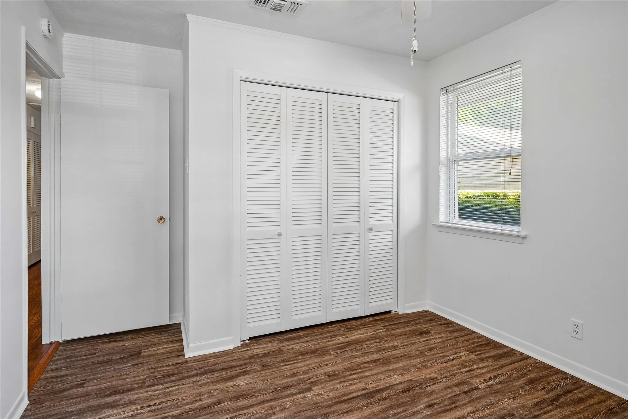 Another view of the front bedroom with a wood look vinyl flooring and spacious closet