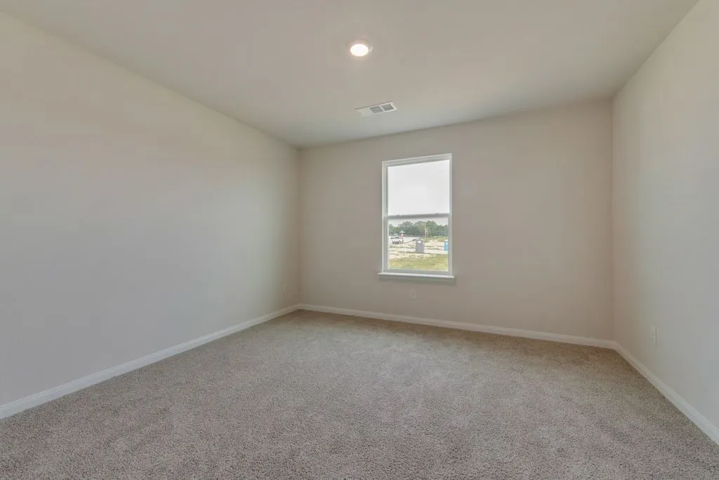 Neutral tone wall paint, recessed lighting, single window, and plush carpet flooring