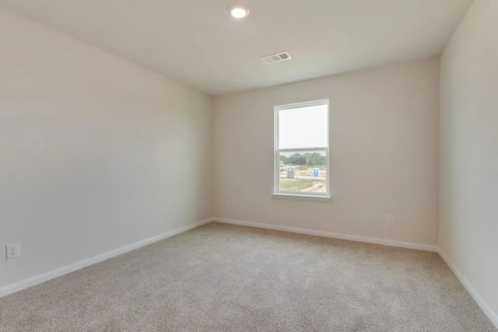 Recessed ceiling light, neutral wall paint, single window, and carpeted flooring