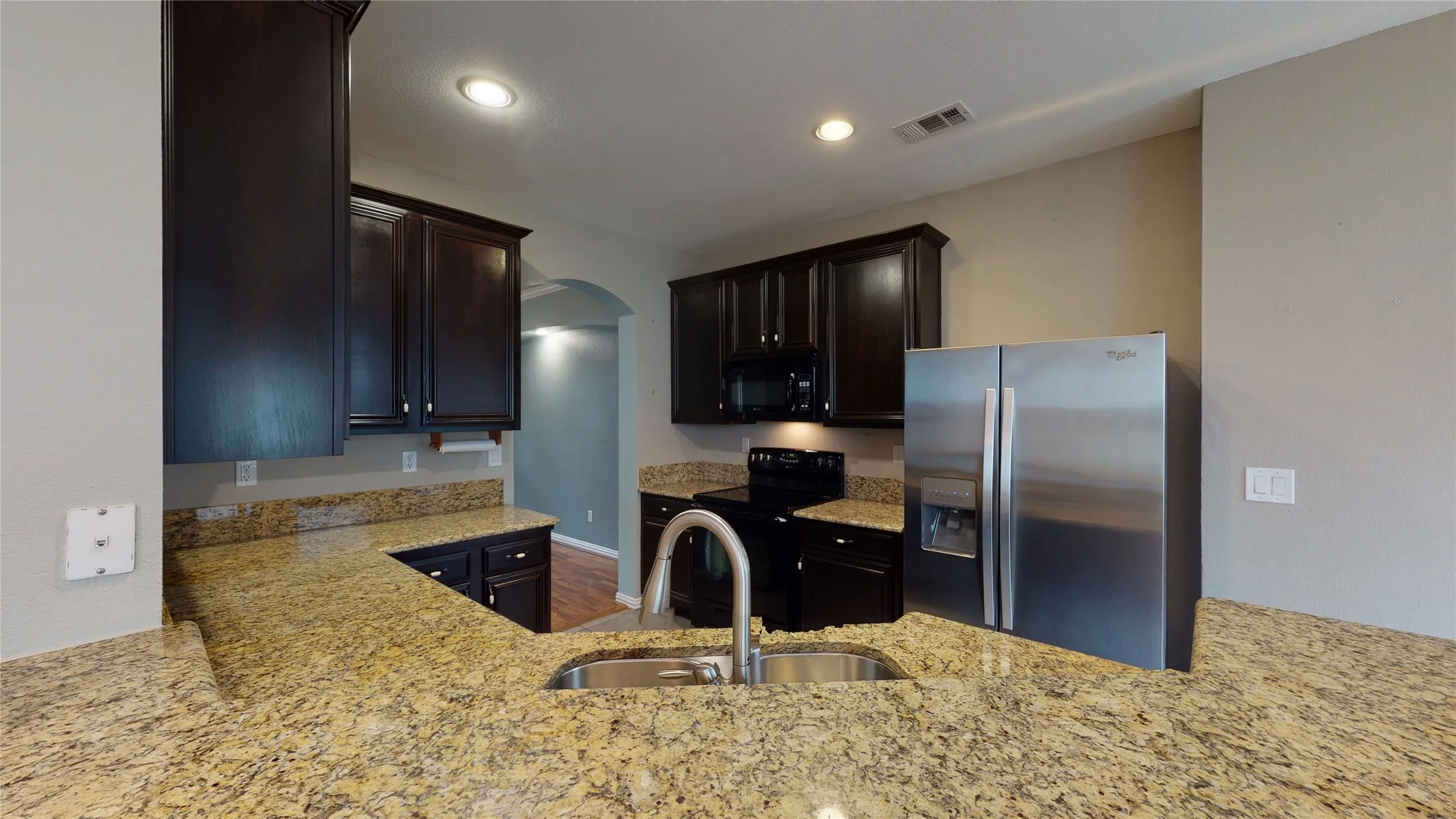 Granite counters and large cabinets along with stainless steel appliances