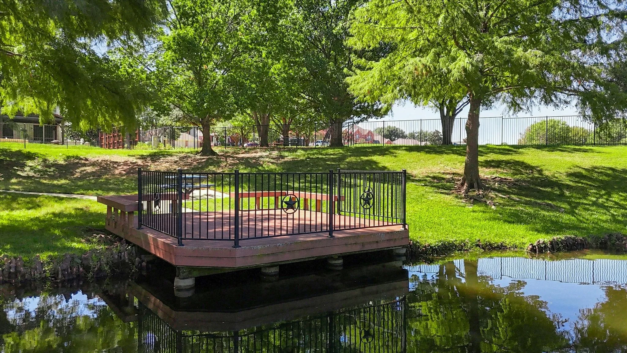 Waterfront deck with dark railing and decorative metal star accents