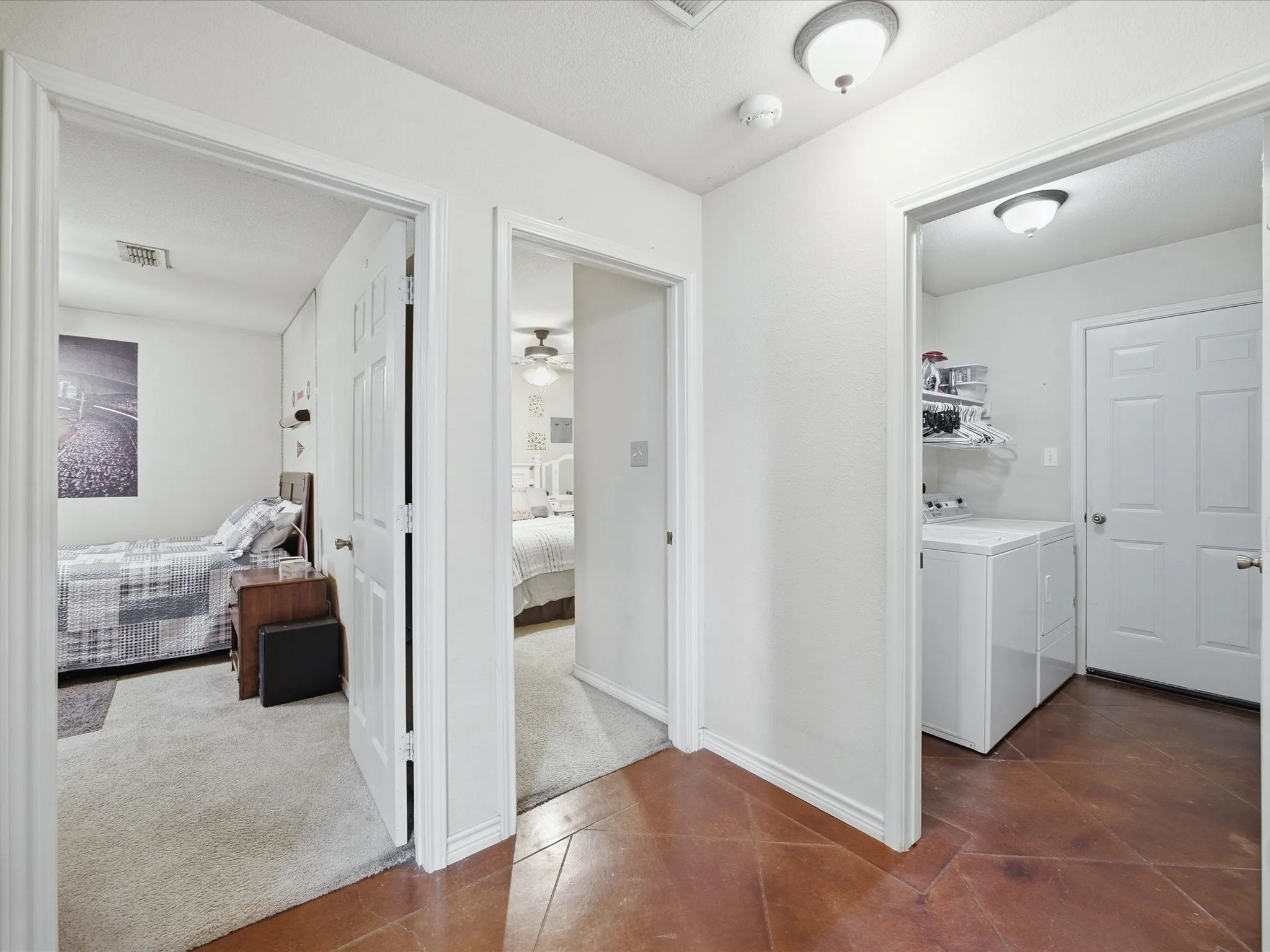 These are the doors to both secondary bedrooms & a view of the laudnry room